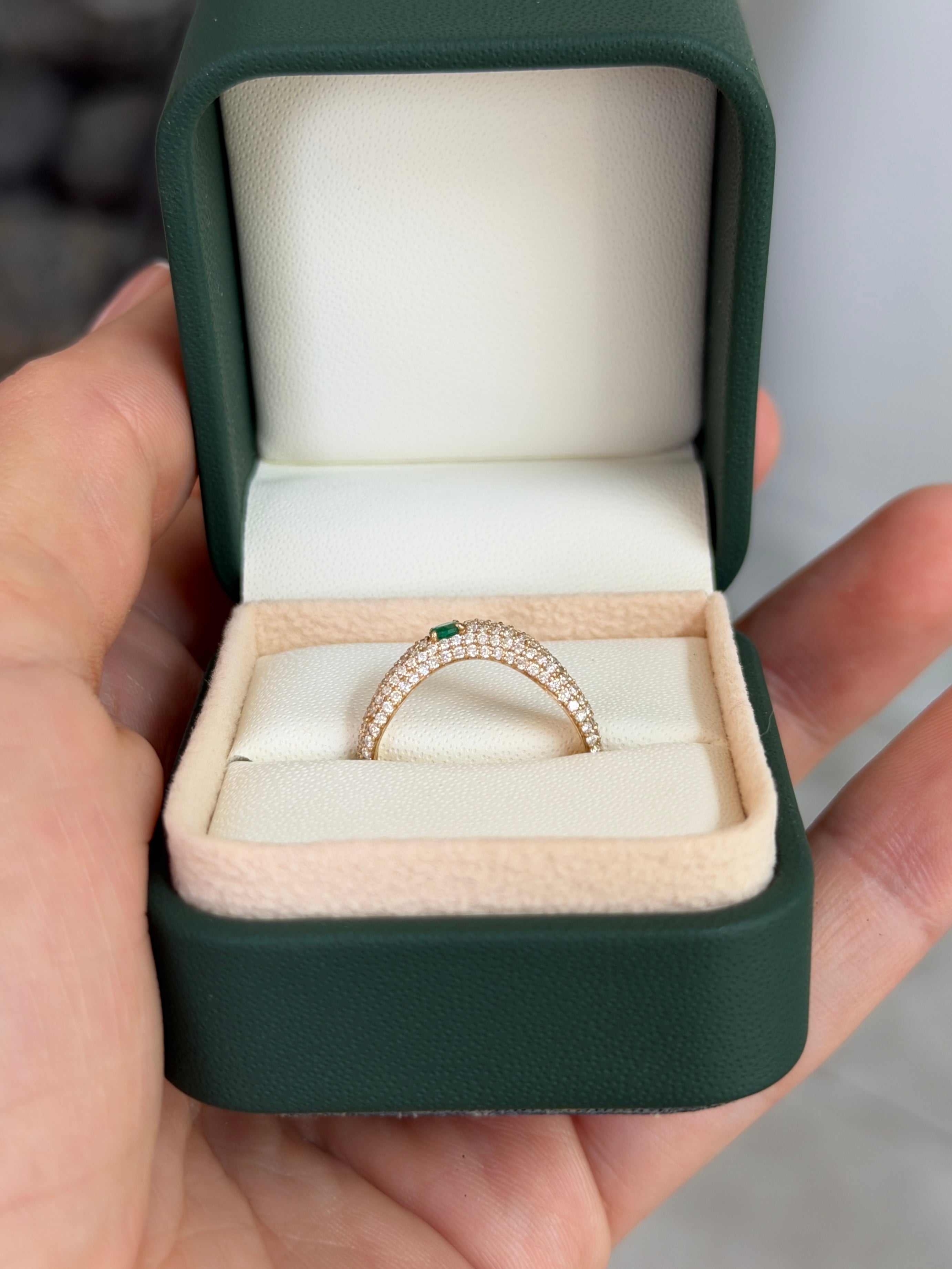 Custom curved emerald and diamond pave wedding band in 14K gold by JR Colombian Emeralds, size 7, featuring detailed gemstone setting.
