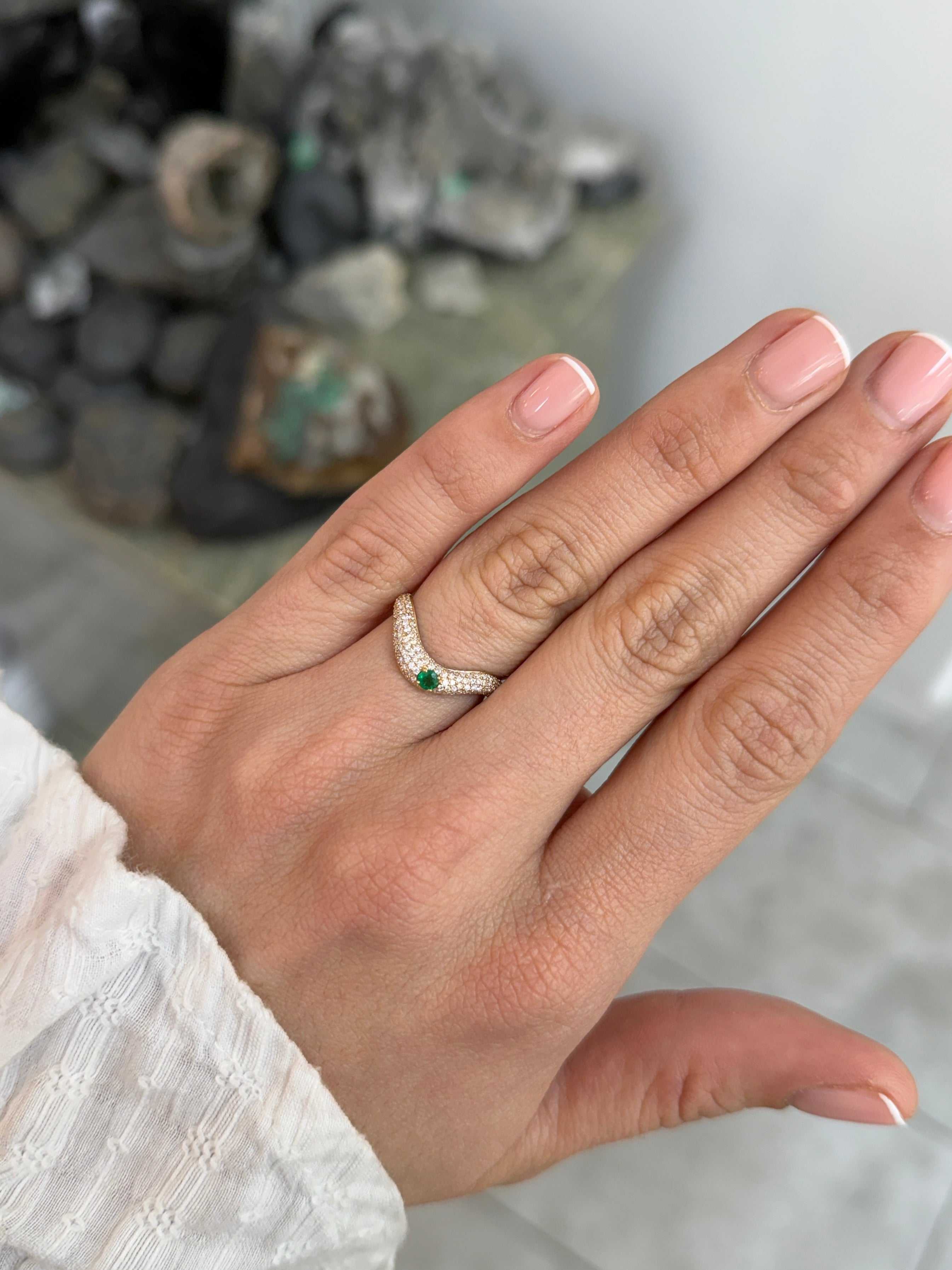 Custom curved emerald and diamond pave wedding band in 14K gold, size 7, from JR Colombian Emeralds featuring detailed gemstone settings.