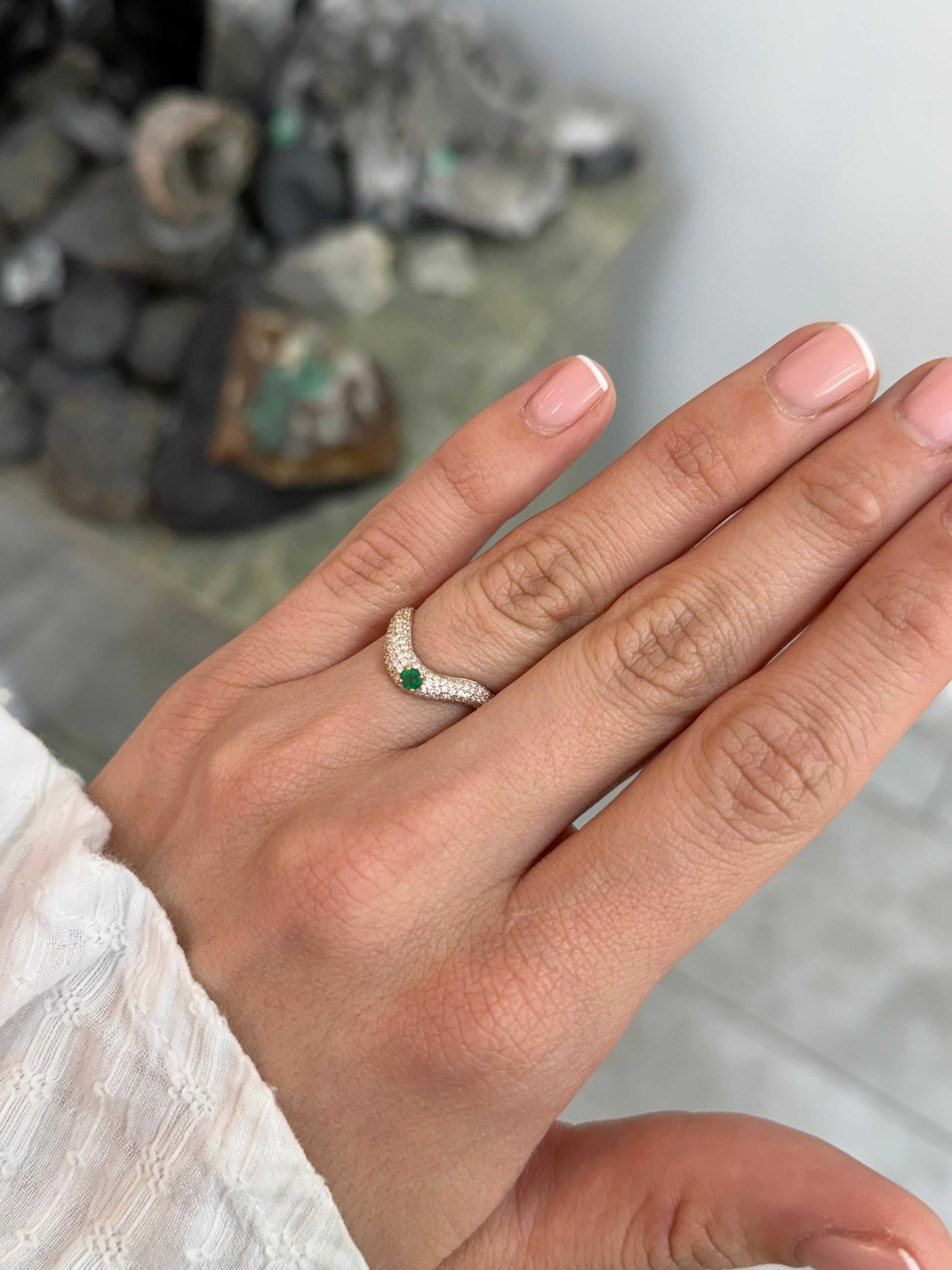 Custom curved emerald and diamond pave wedding band in 14K gold by JR Colombian Emeralds, size 7, featuring intricate gemstone detailing.