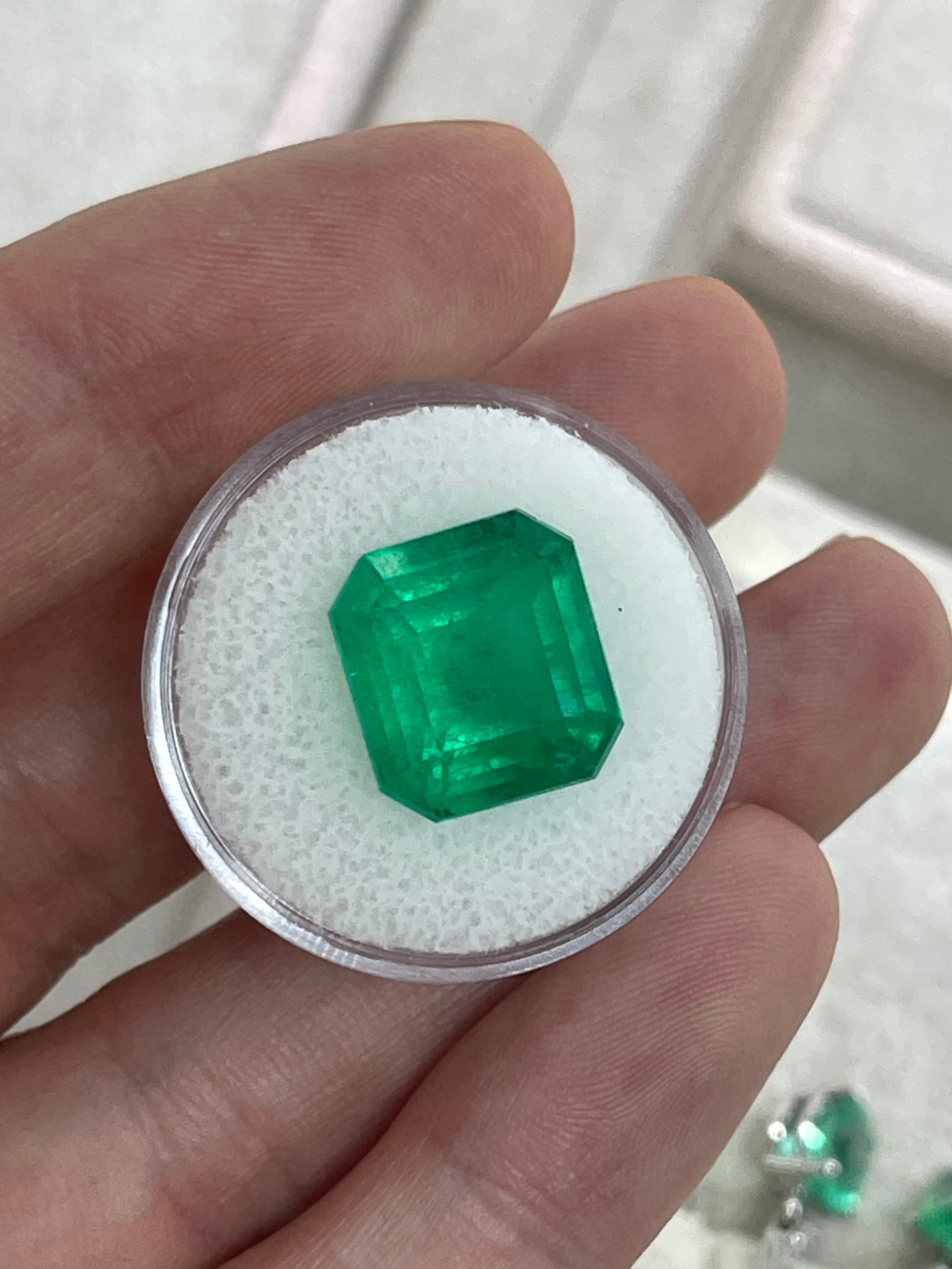 Large 10.13 carat Muzo Colombian emerald in emerald cut, deep jungle green, natural loose gemstone from JR Colombian Emeralds.