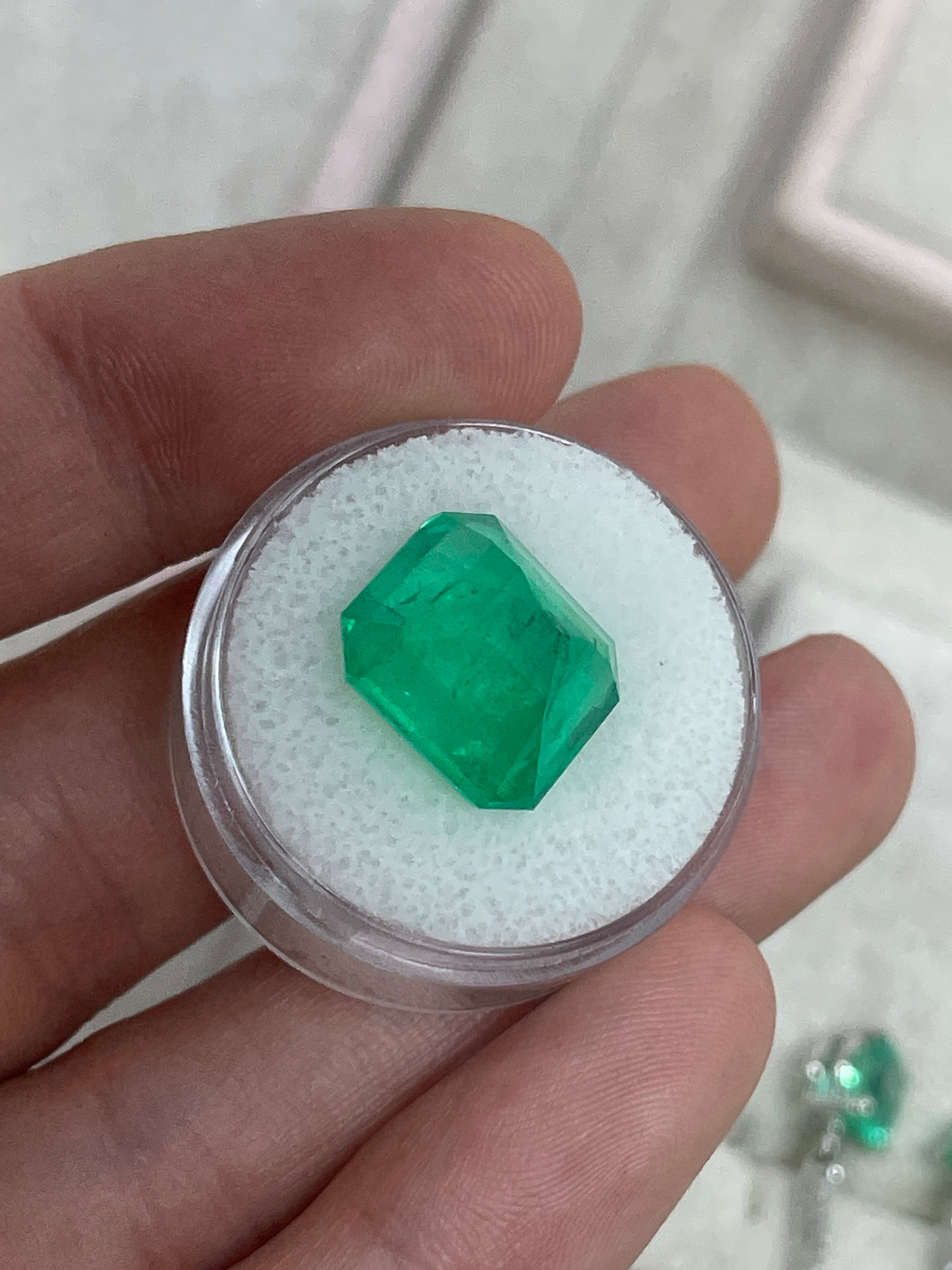 Large 10.13 carat Muzo Colombian emerald in a 14x13 emerald cut, deep jungle green, natural loose gemstone from JR Colombian Emeralds.
