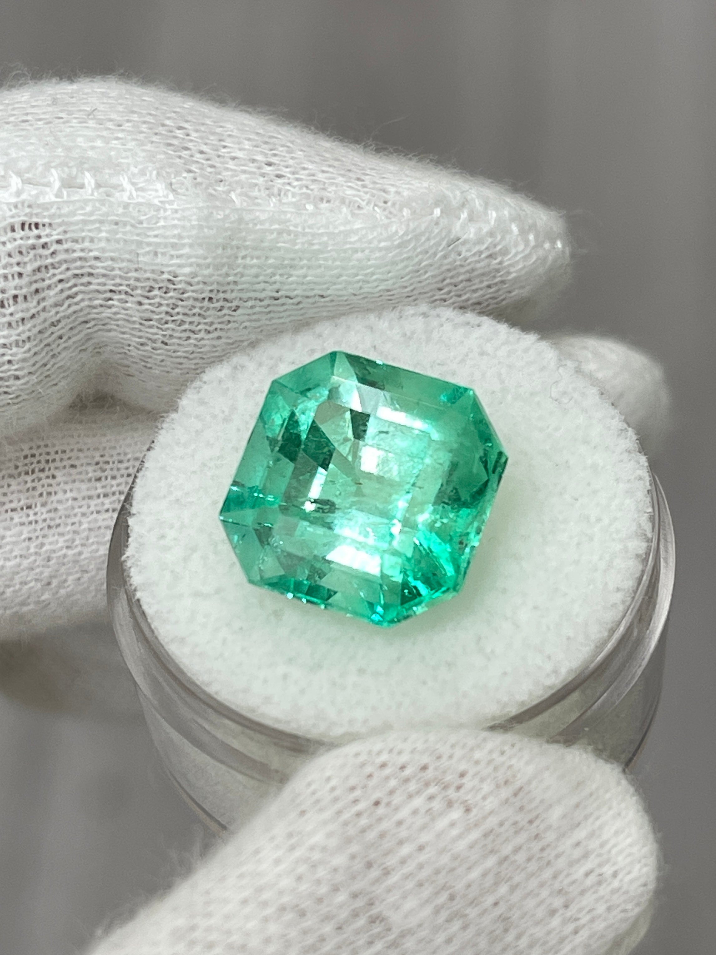 Large 10.49 carat natural Colombian emerald in classic 13x13 Asscher cut, vibrant green gemstone with brilliant clarity.
