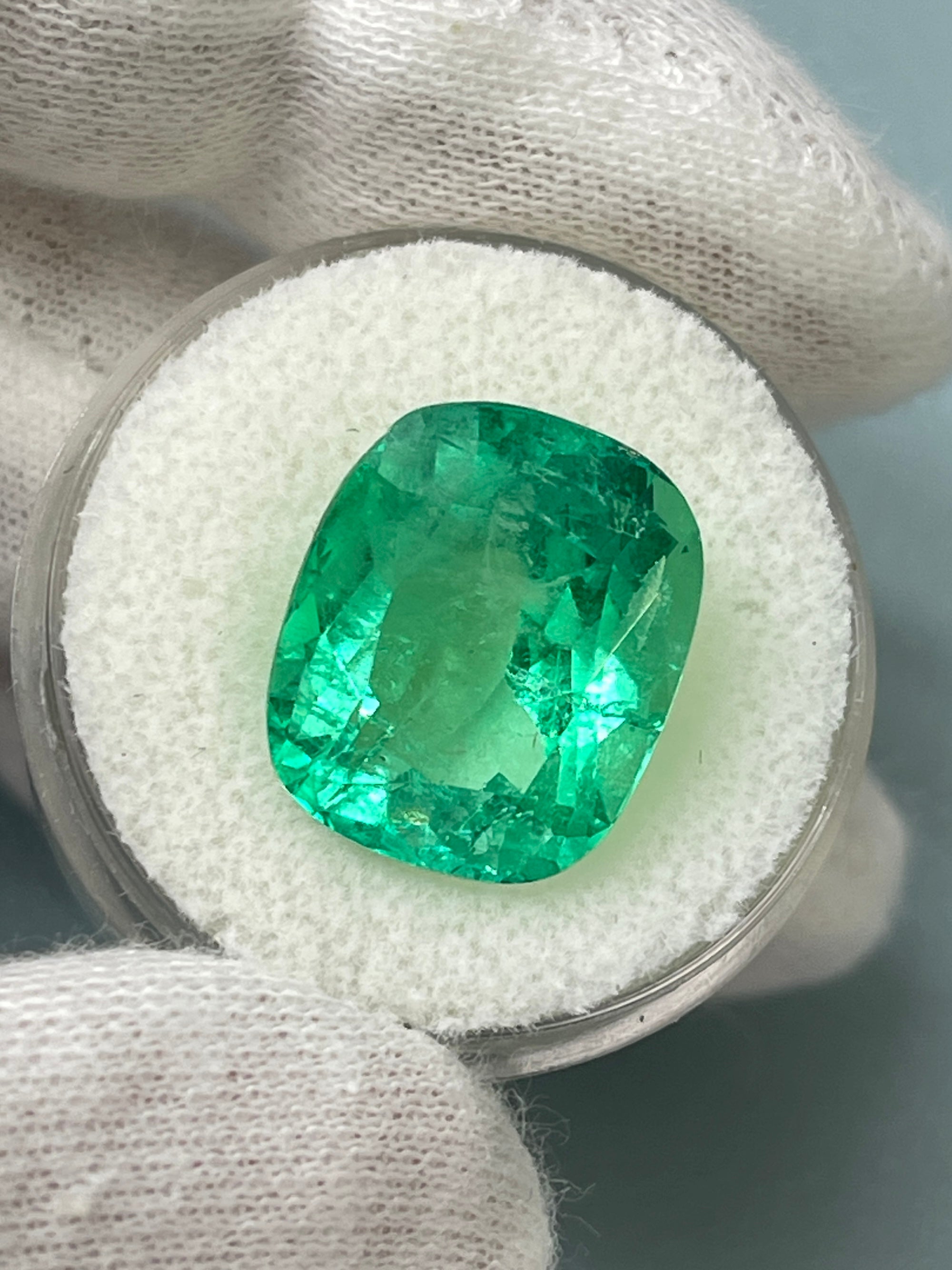 Large 11.50 Carat yellowish Colombian emerald cushion cut with spready brilliance, natural Muzo gemstone by JR Colombian Emeralds.