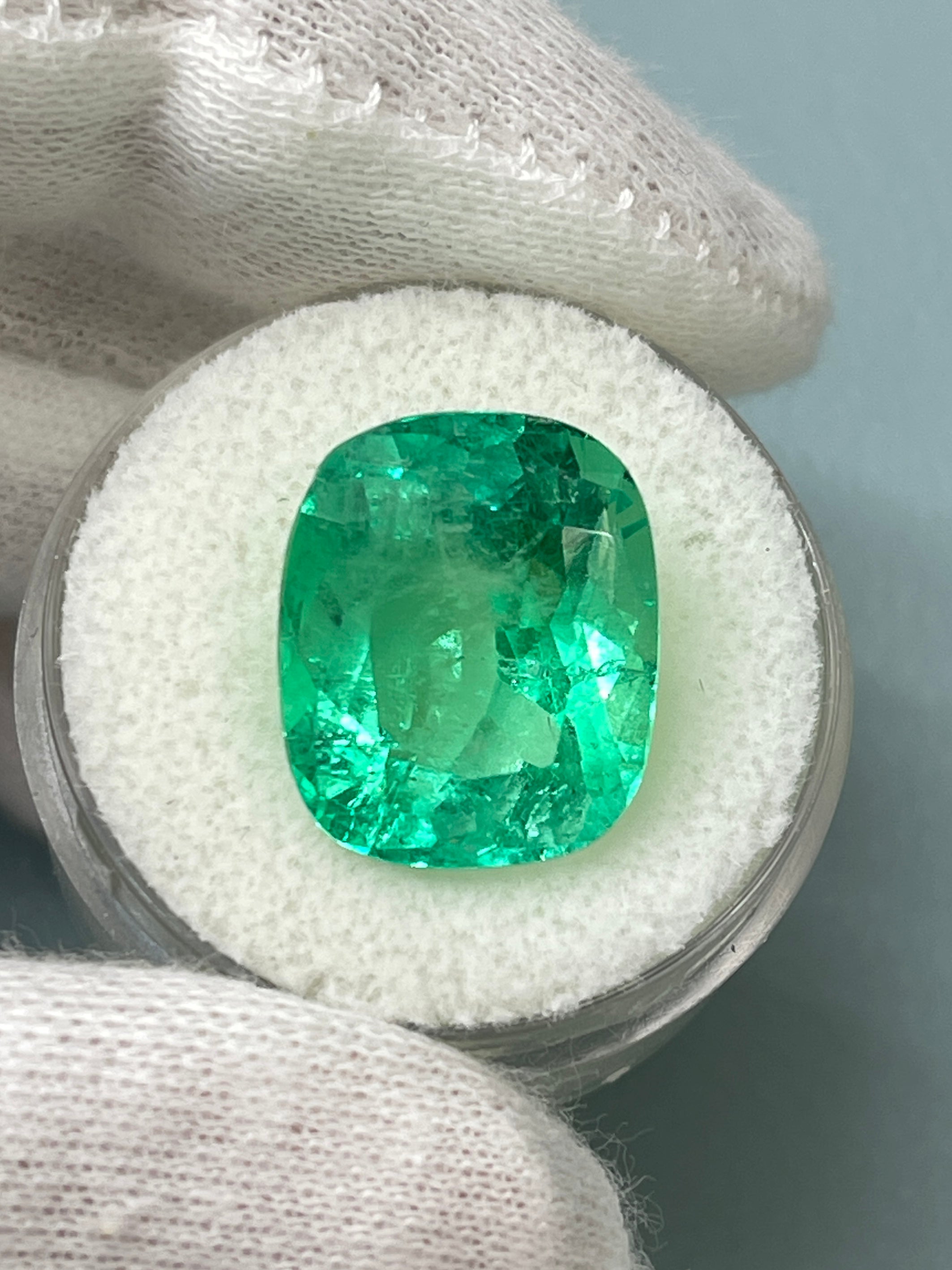 Large 11.50 carat yellowish Colombian emerald cushion cut with natural spready Muzo green hue, from JR Colombian Emeralds.
