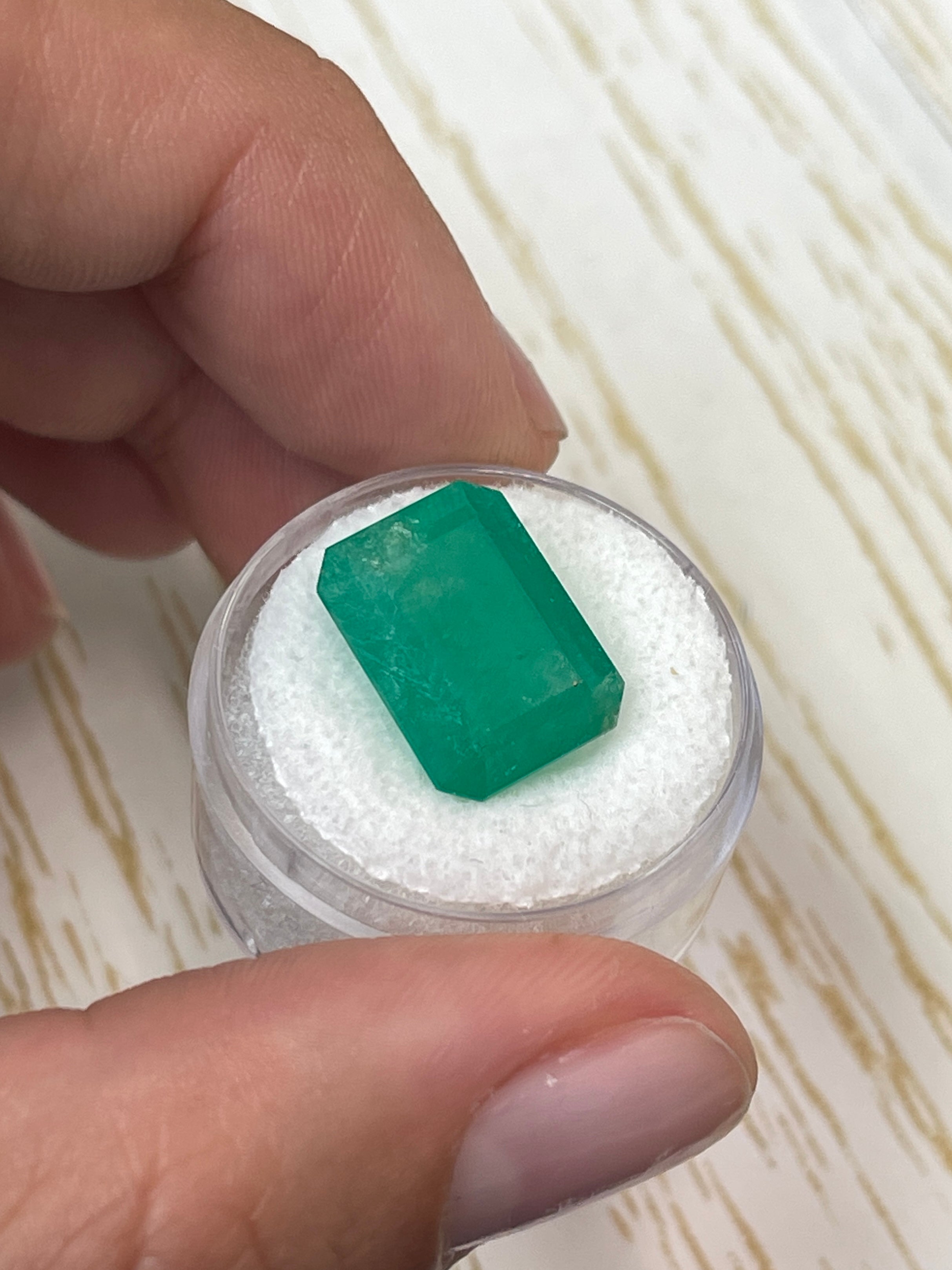 Large 12.13 carat natural Colombian emerald in an emerald cut, showcasing vibrant green color and clarity.