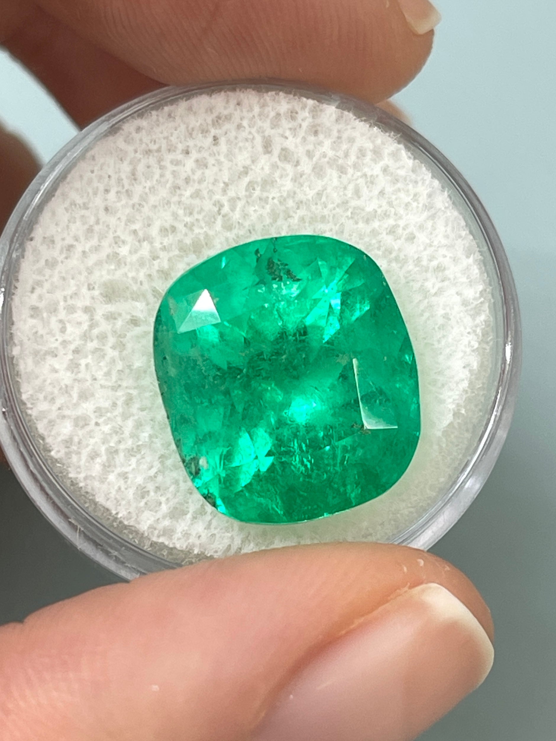Large 12.27 carat Muzo yellowish green Colombian emerald loose cushion cut gemstone, natural and vibrant.