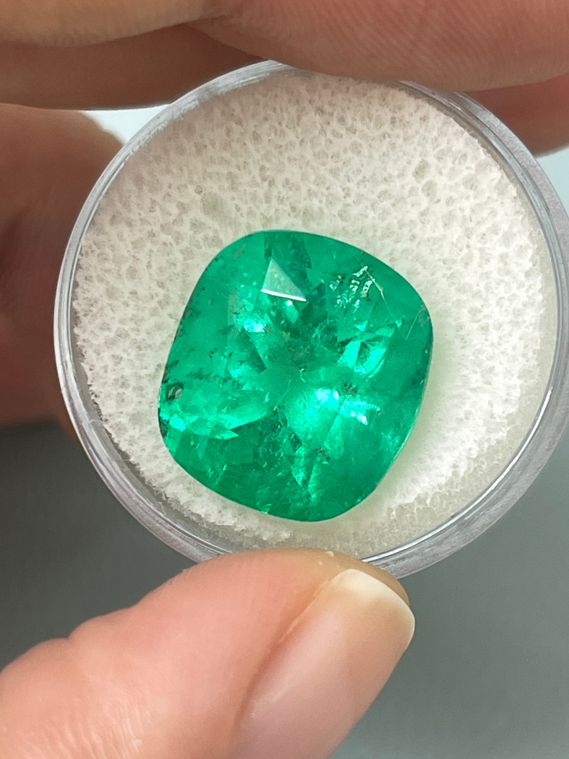 Large 12.27 carat Muzo yellowish green Colombian emerald loose cushion cut gemstone from JR Colombian Emeralds.