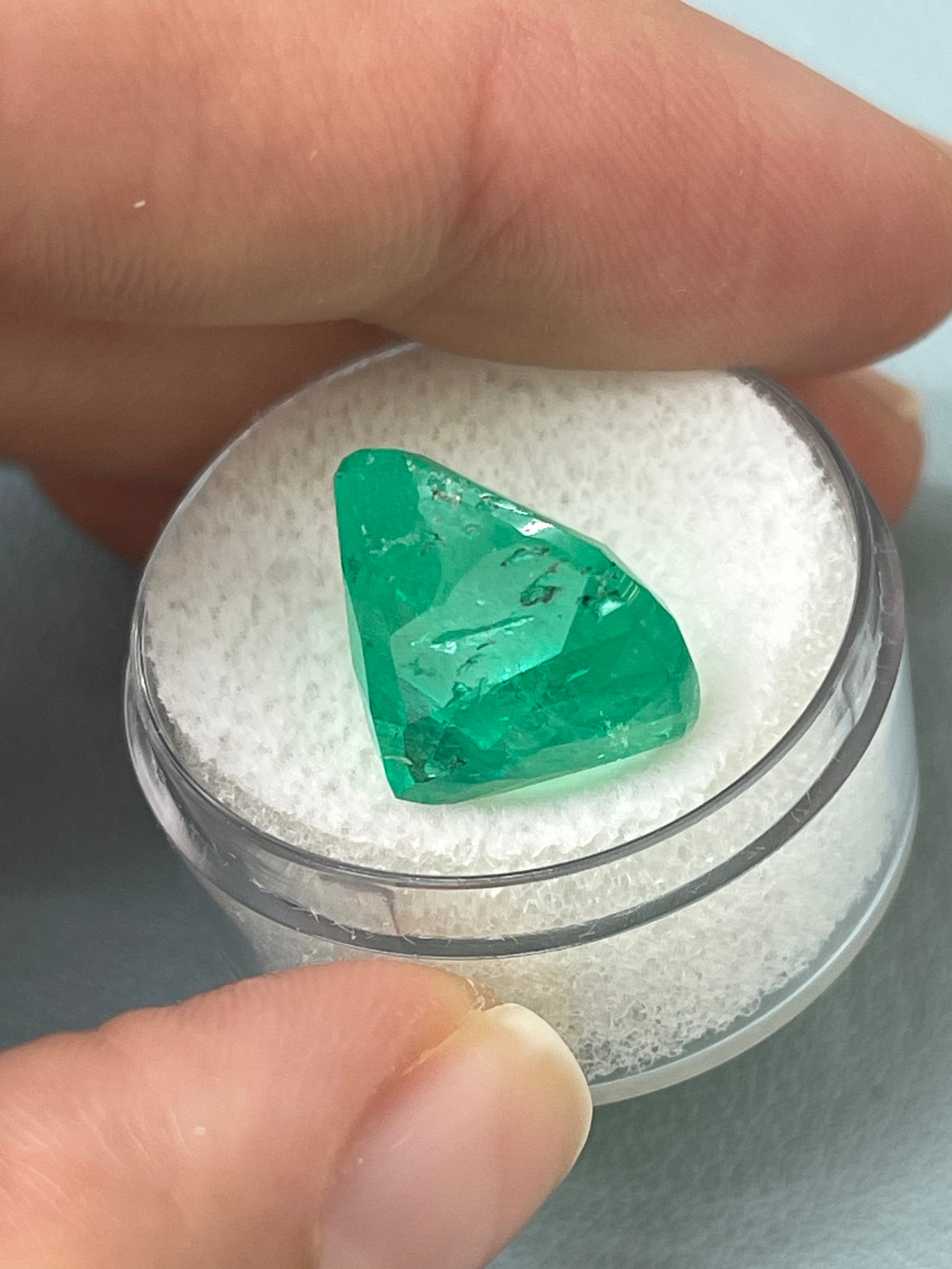 Large 12.27 carat Muzo yellowish green Colombian emerald loose cushion cut gemstone from JR Colombian Emeralds.