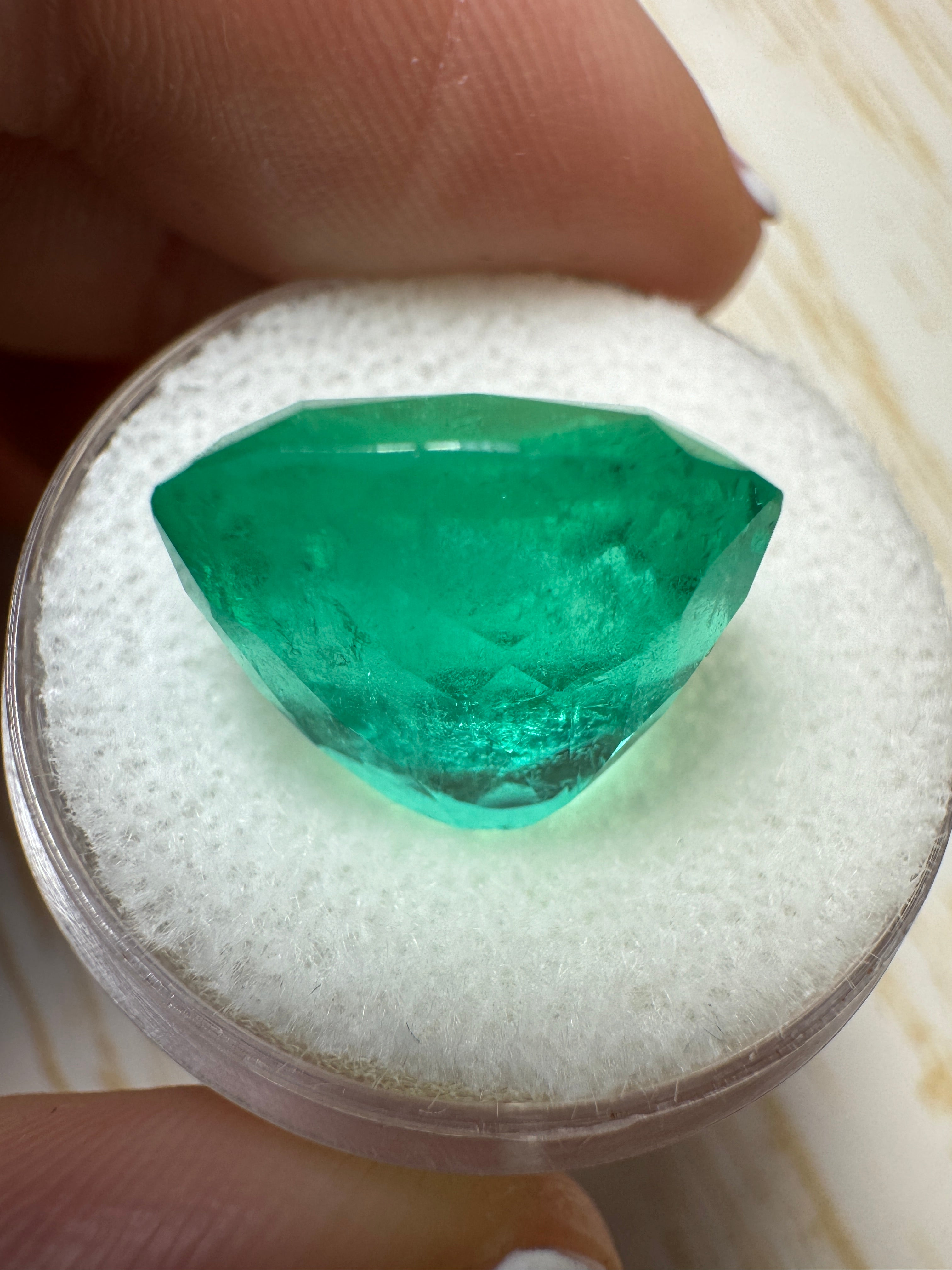 Large 12.50 carat green Colombian emerald loose cushion cut gemstone from JR Colombian Emeralds. Natural and stunning.