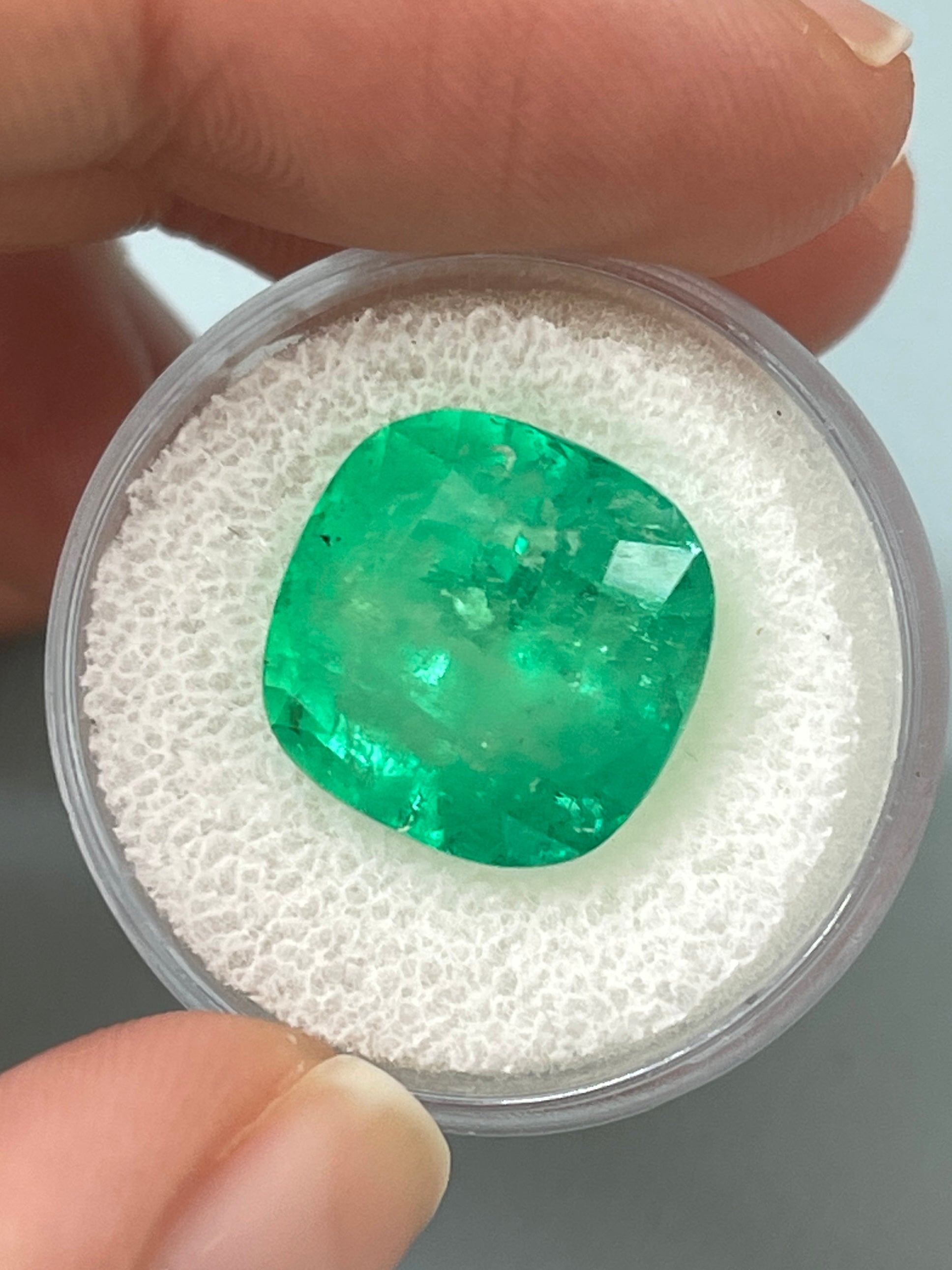 Large 12.66 carat natural Colombian emerald in cushion cut, vibrant green gemstone with 14x14 mm dimensions.