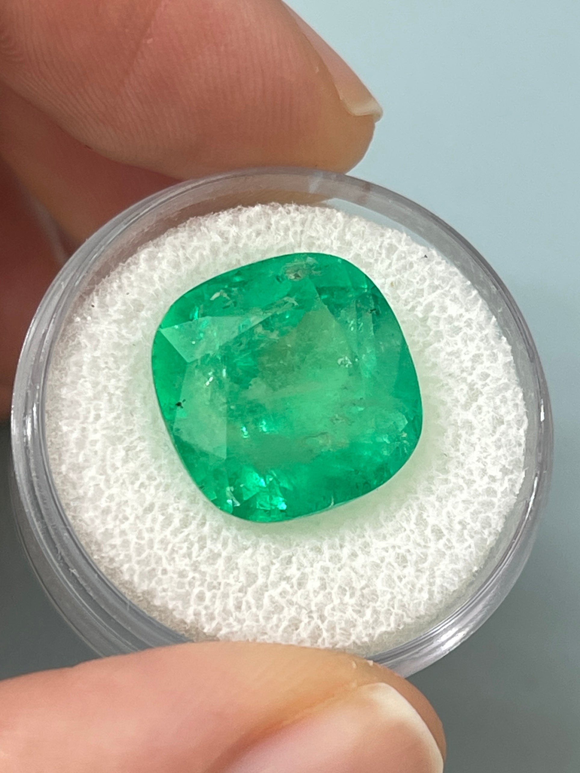 Large 12.66 carat natural Colombian emerald in cushion cut, 14x14mm, showcased by JR Colombian Emeralds.