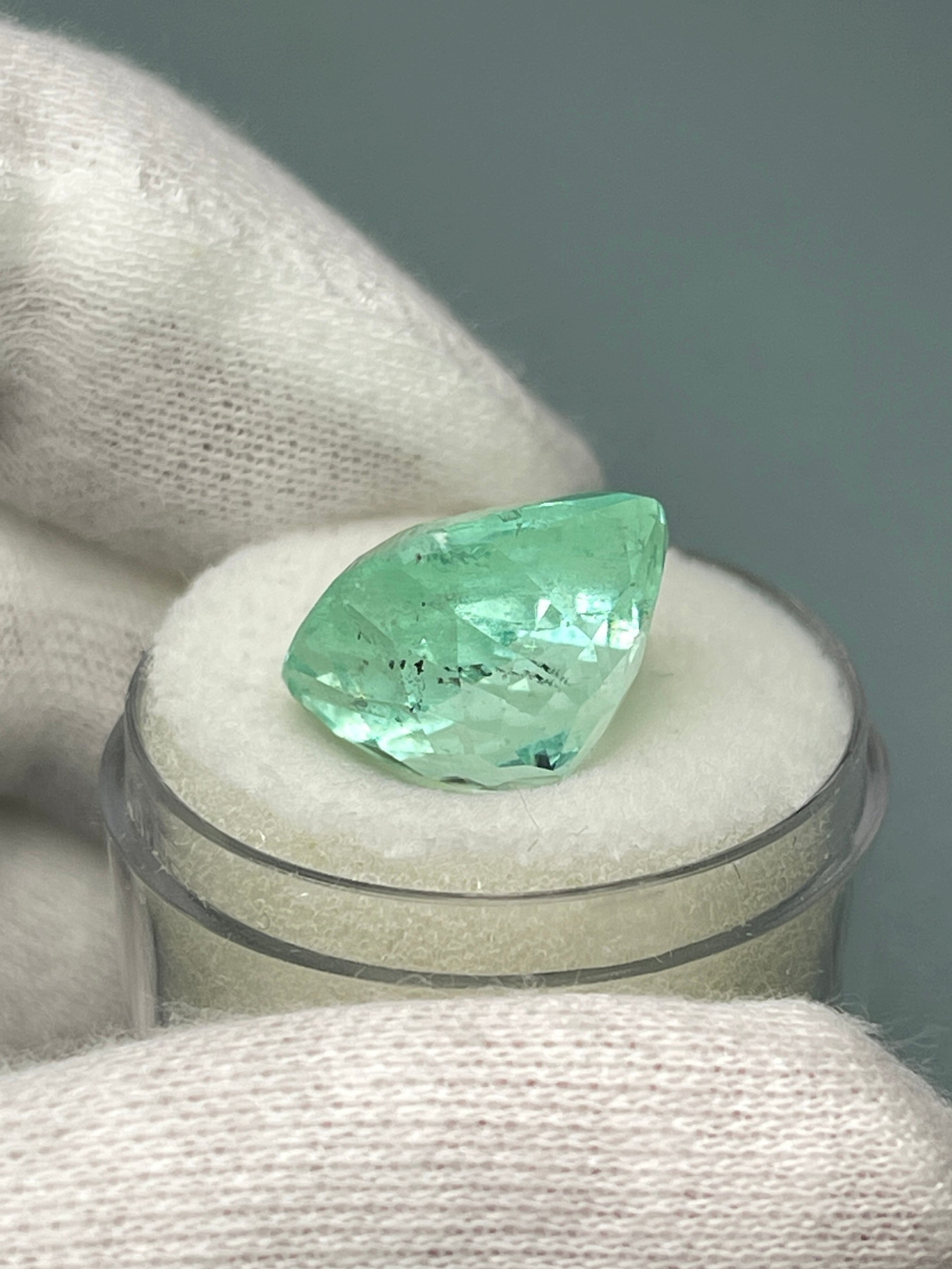 Large 12.86-carat natural cushion-cut Colombian emerald from JR Colombian Emeralds, showcasing vibrant green color and clarity