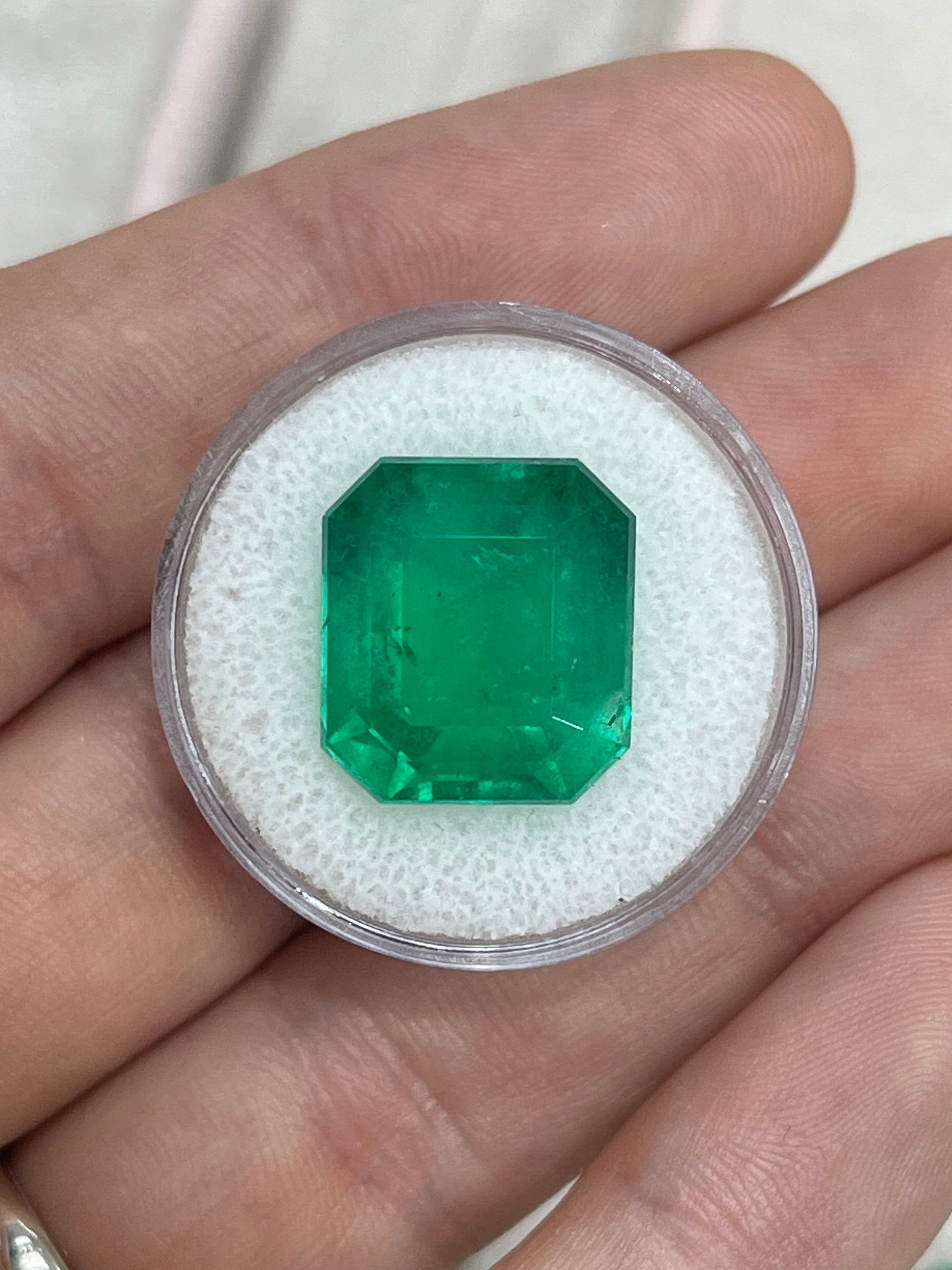 Large 13.04 carat AAA+ Colombian emerald in an emerald cut, showcasing vibrant green color and clarity.