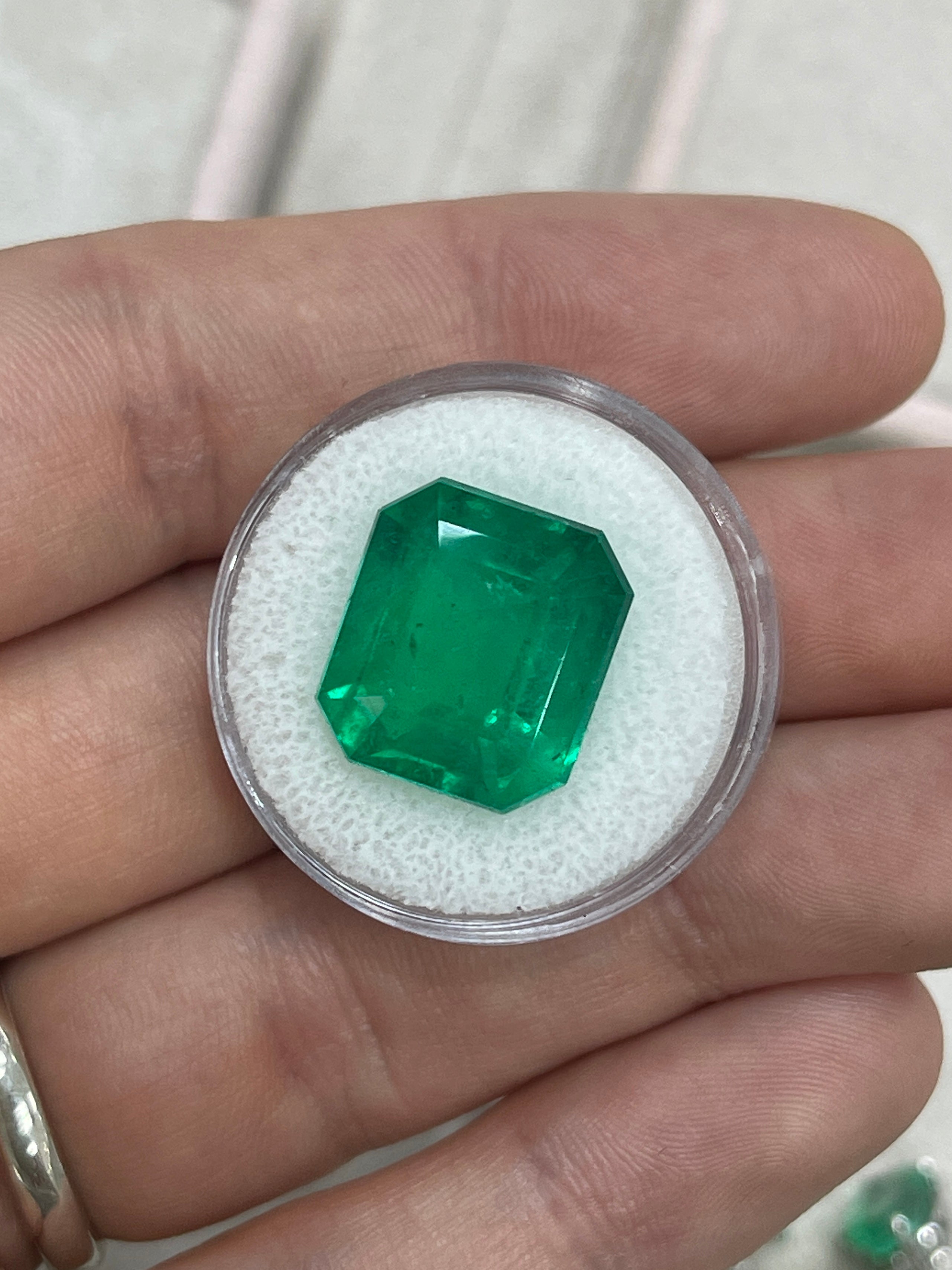 Large 13.04 carat AAA+ Colombian emerald cut loose emerald from JR Colombian Emeralds, showcasing vibrant green color and clarity.