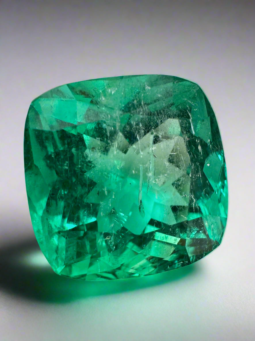 Large 13.88-carat bluish green cushion cut Colombian emerald, loose, ethically mined, from JR Colombian Emeralds.