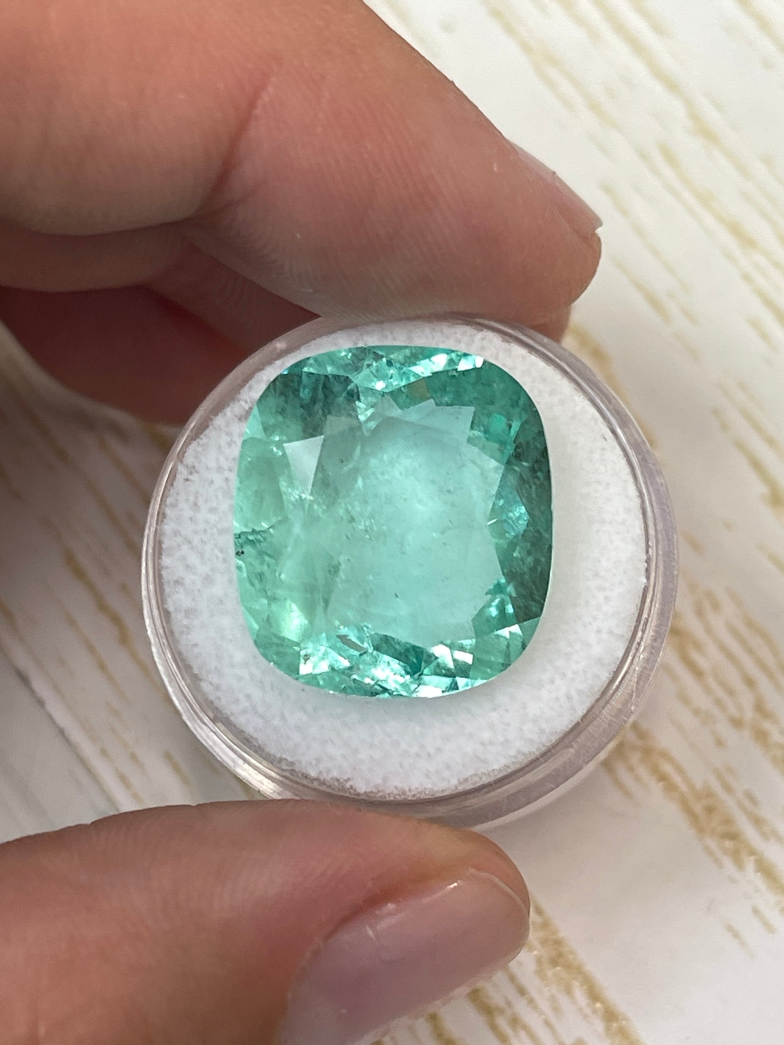 Large 19.41 carat pastel green Colombian emerald loose cushion cut from JR Colombian Emeralds.