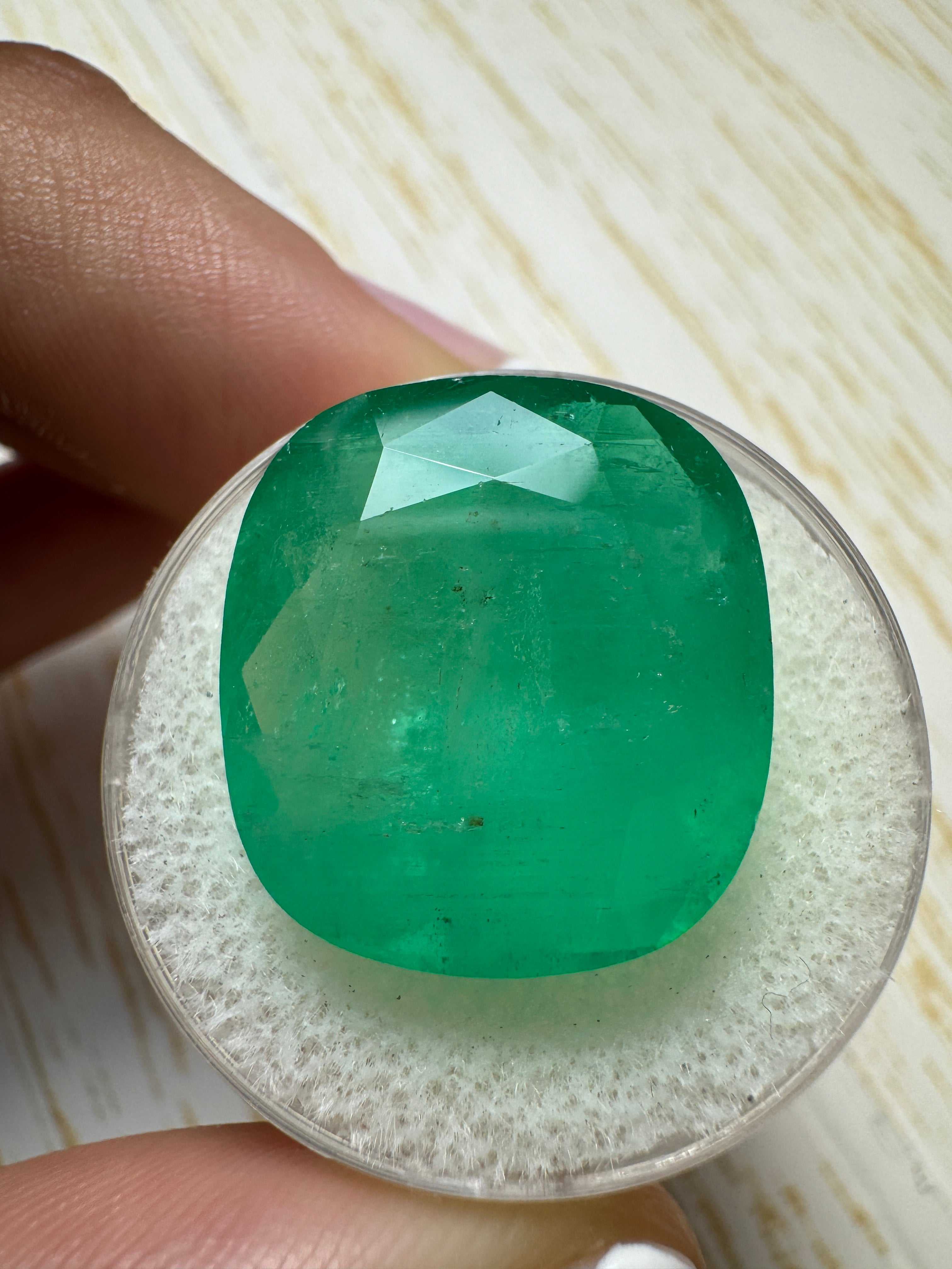 Large 21.62 carat natural Colombian emerald cushion cut with earthy green hue, loose gemstone by JR Colombian Emeralds.