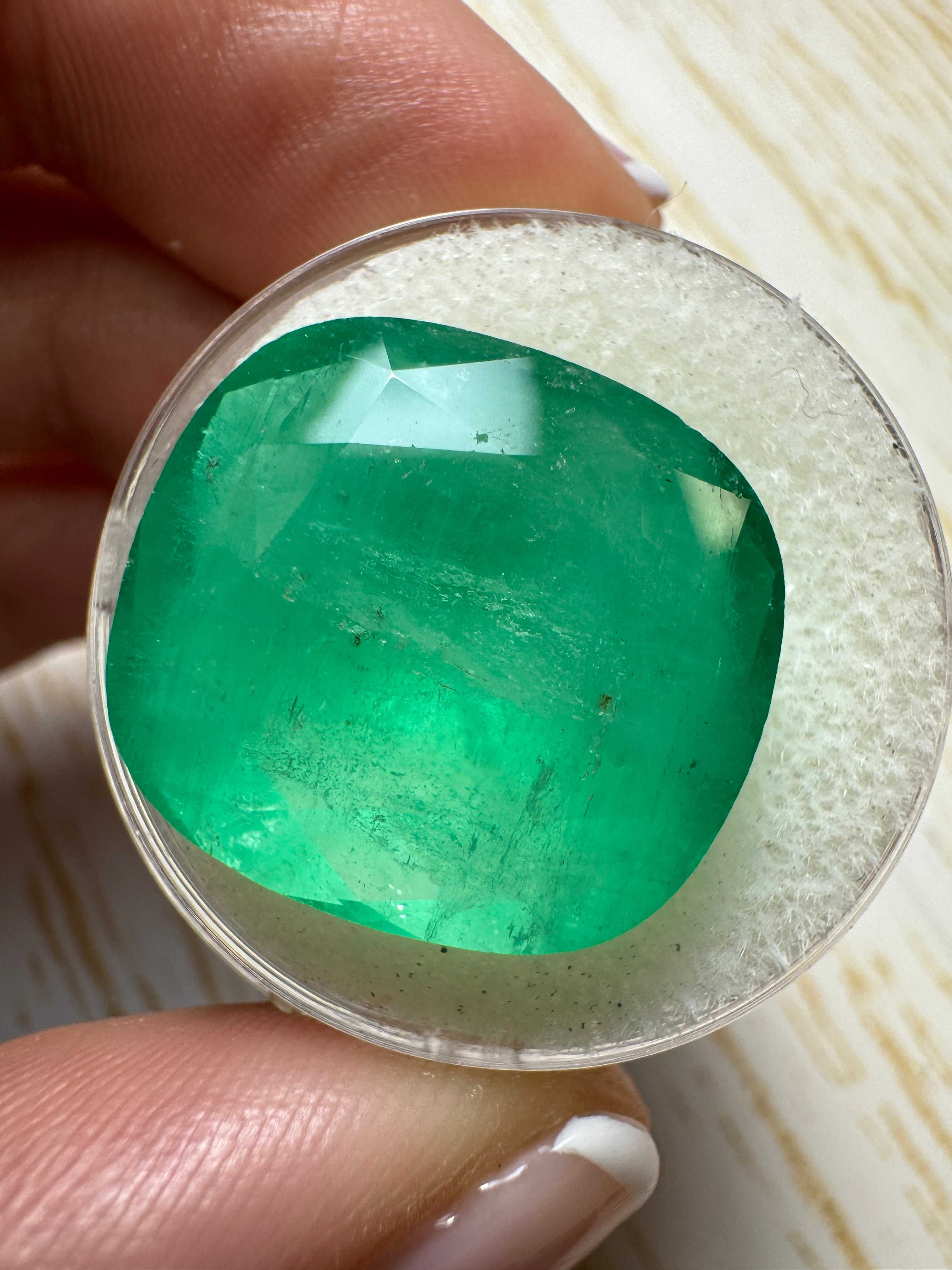 Large 21.62 carat natural Colombian emerald loose gemstone, cushion cut with earthy green hue, from JR Colombian Emeralds.