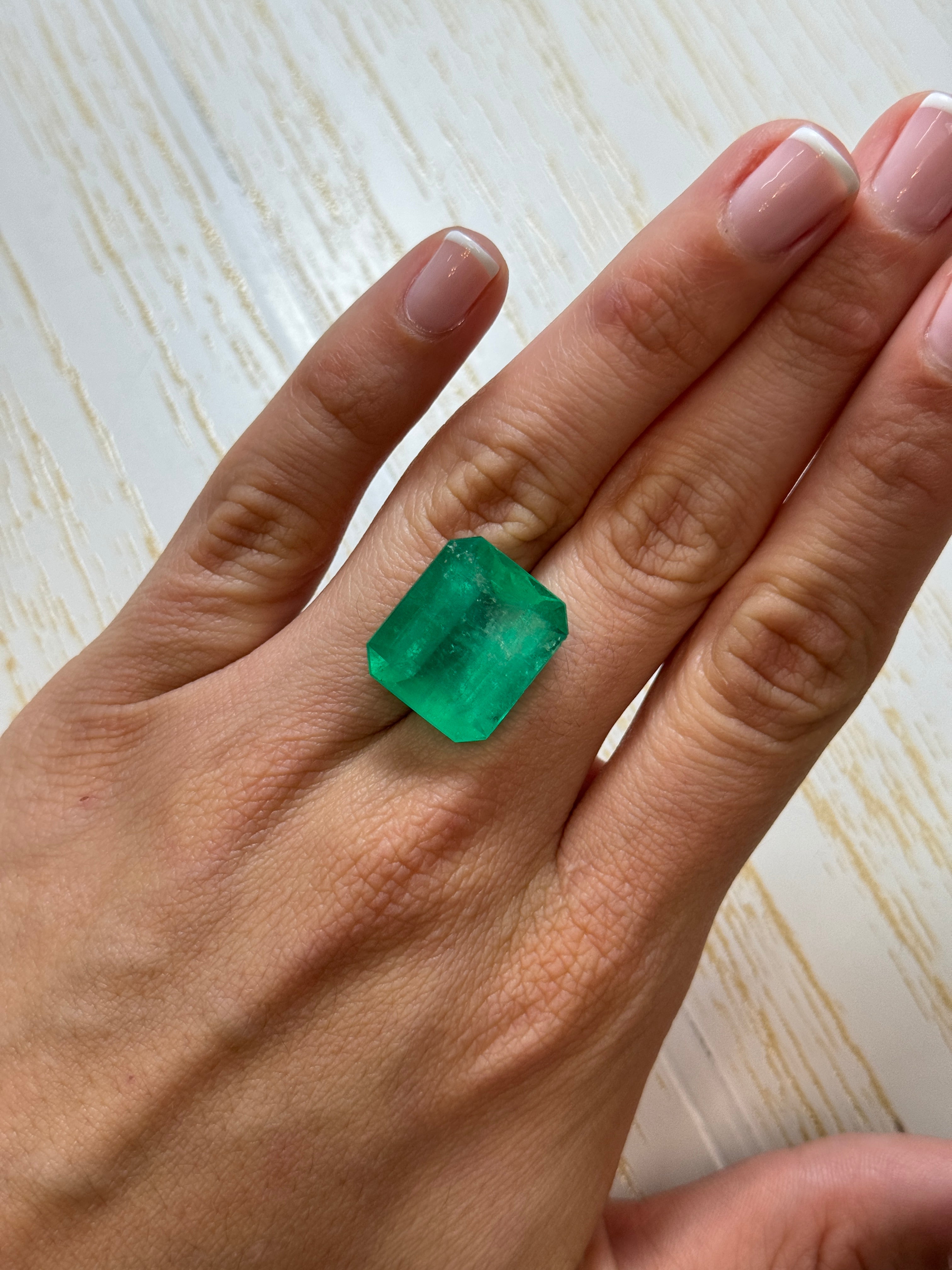 Large 22.54 carat natural Colombian emerald in classic emerald cut, showcasing vibrant green color and clarity.