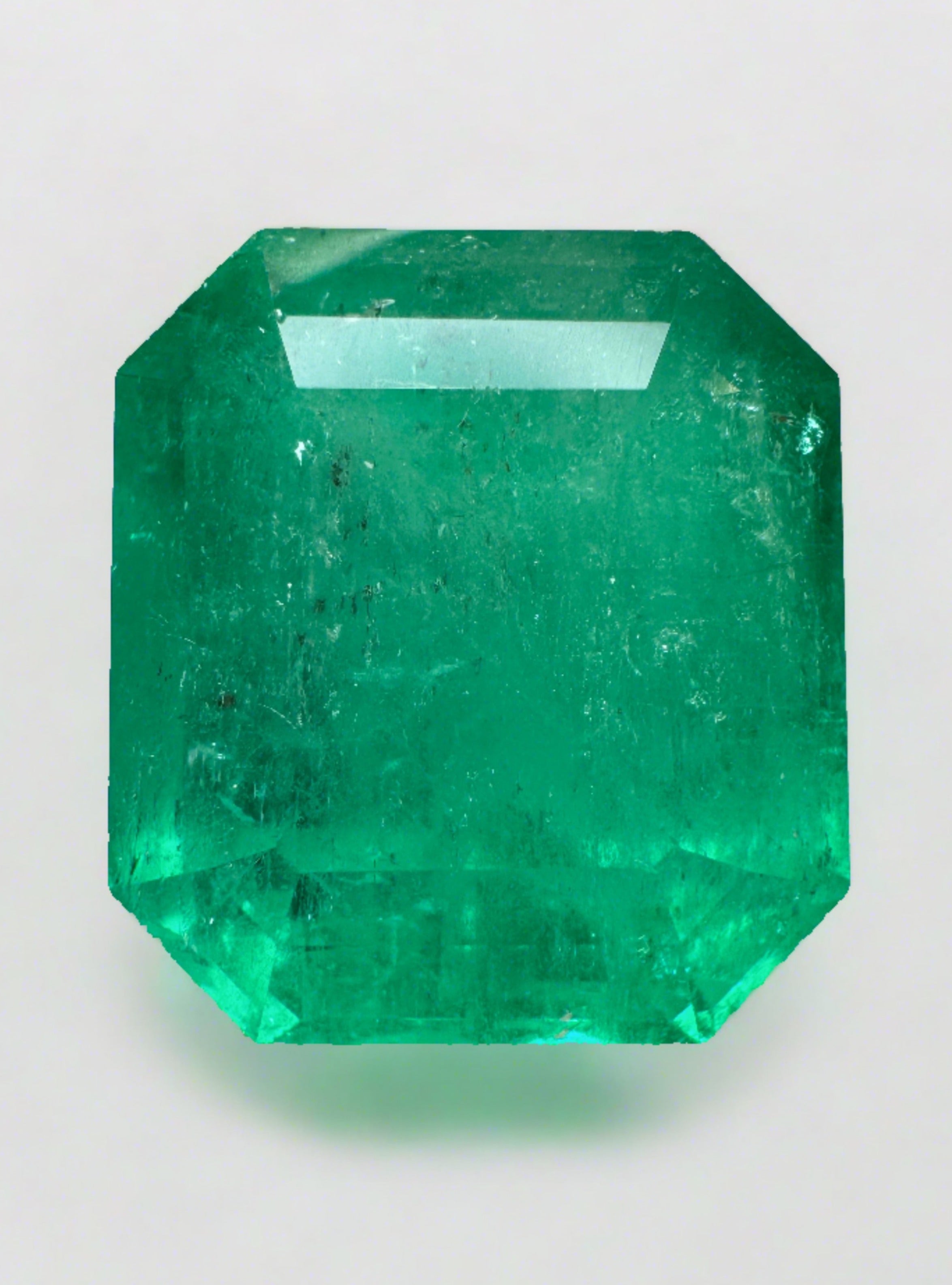 Large 23.85-carat natural Colombian emerald loose gemstone in an emerald cut, showcasing vibrant green color and clarity.