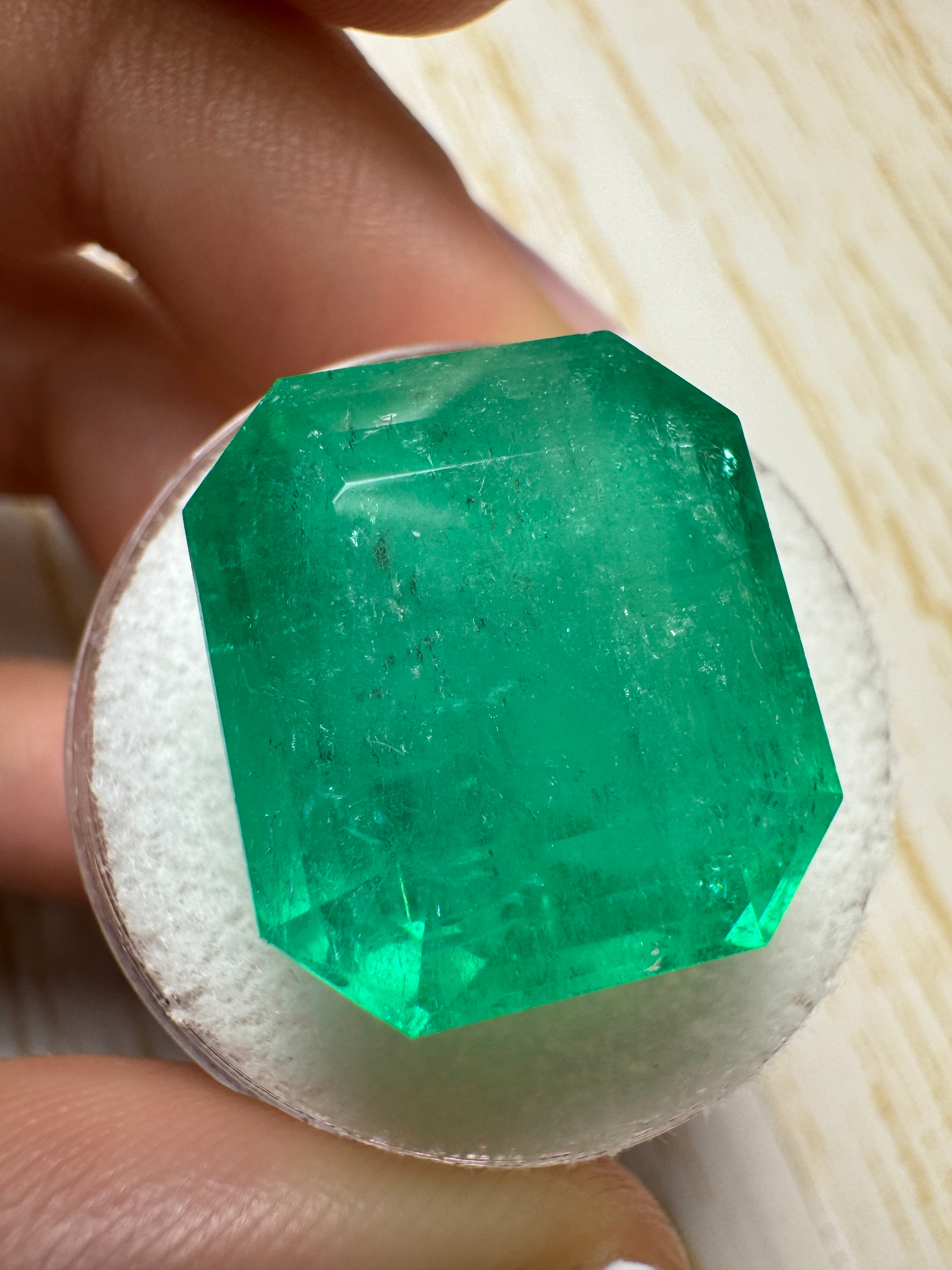 Large 23.85 carat natural Colombian emerald in classic emerald cut, showcasing vibrant green color and clarity.