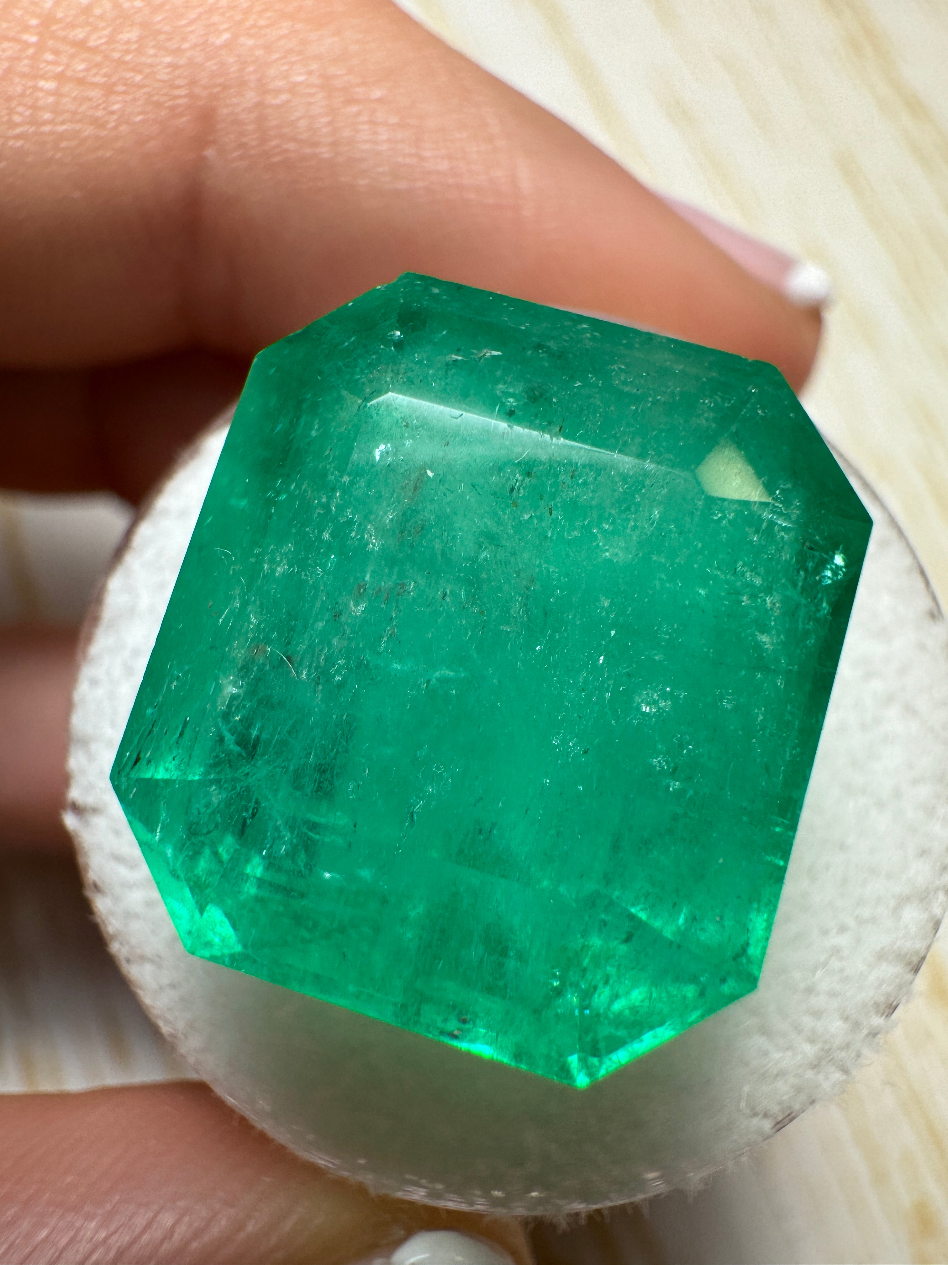 Large 23.85 carat natural Colombian emerald loose gemstone in an emerald cut, showcasing vibrant green color and clarity.