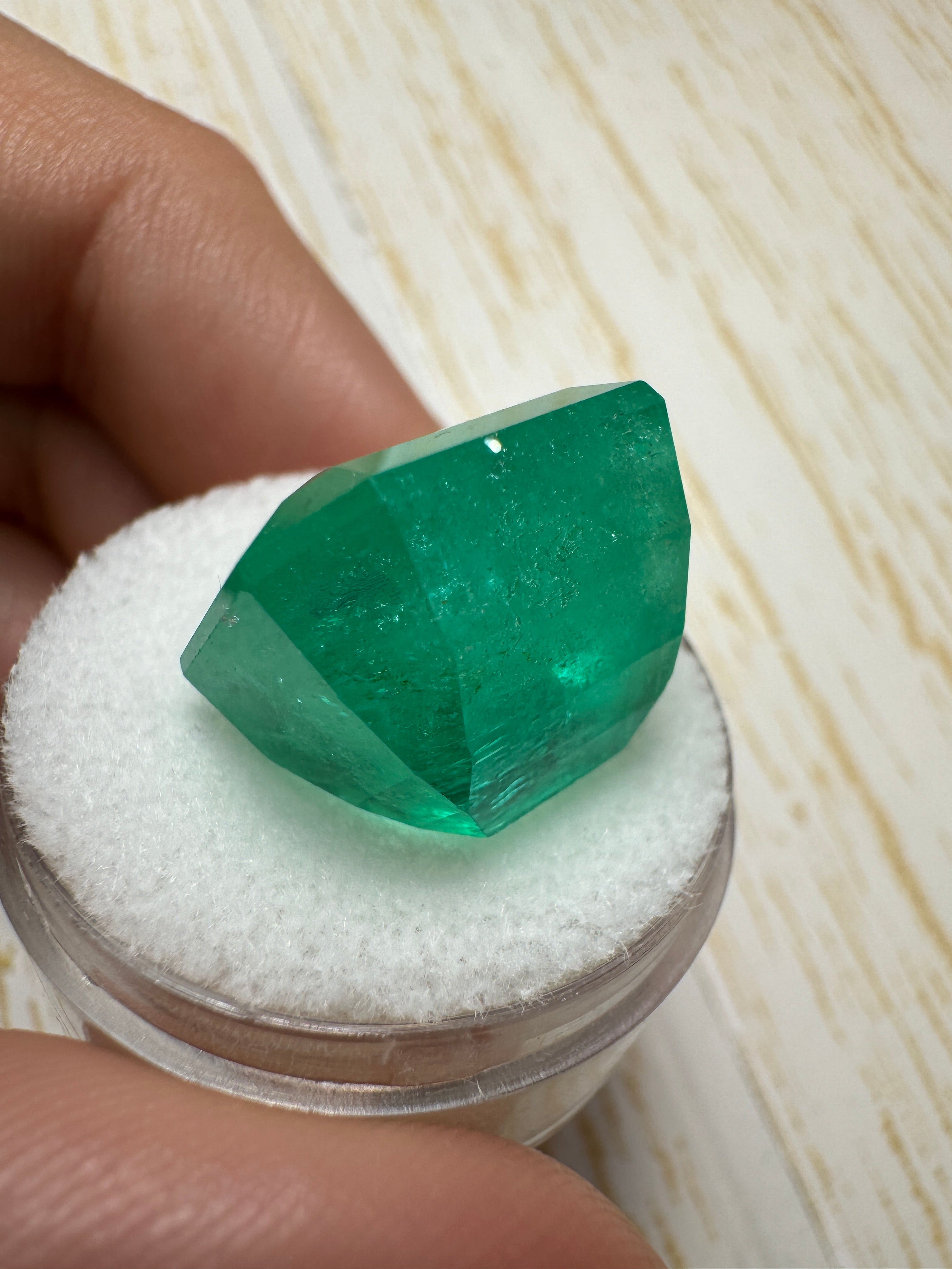 Large 23.85-carat natural Colombian emerald in an emerald cut, showcasing vibrant green color and clarity.