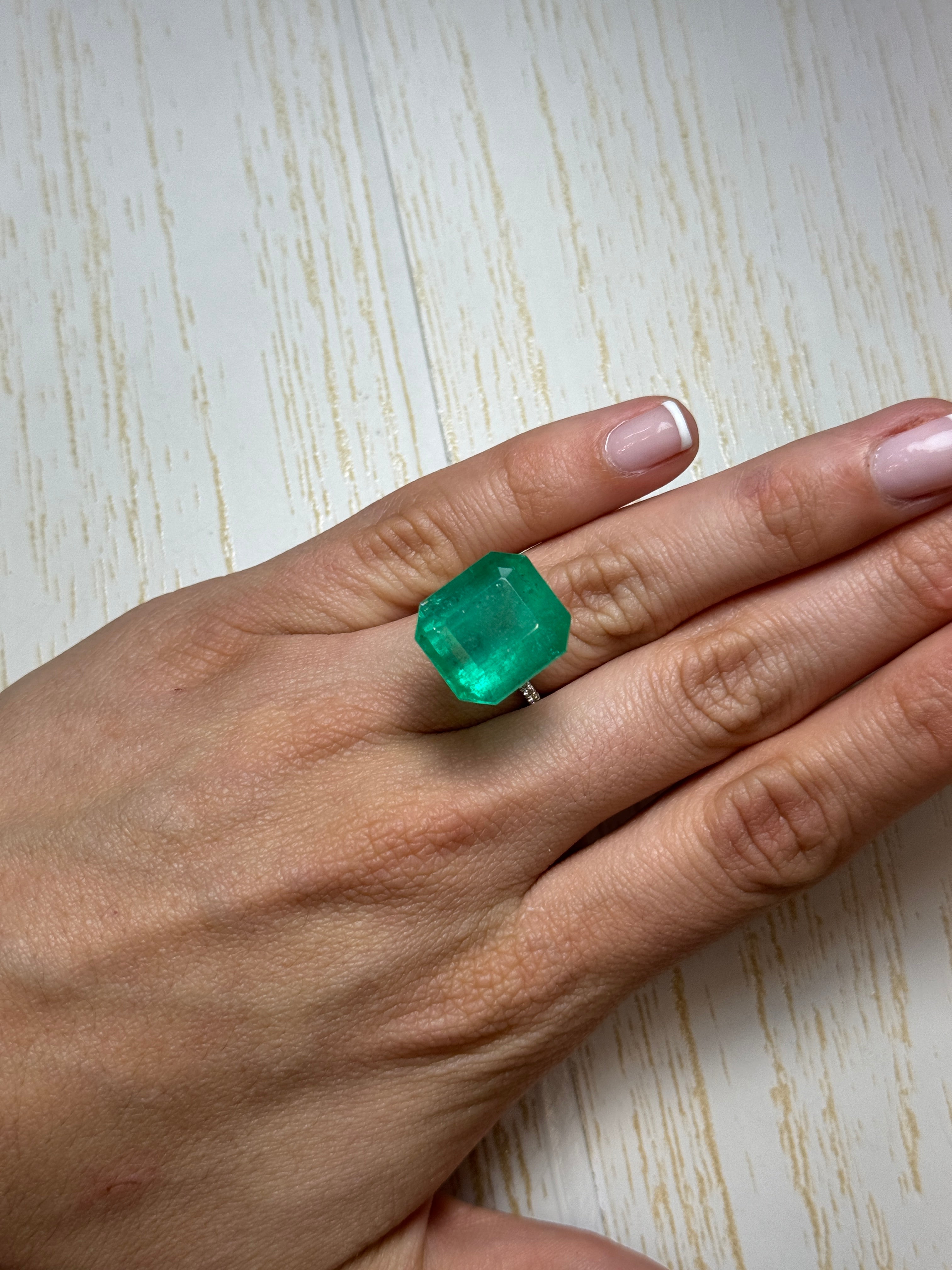 Large 23.85 carat Colombian emerald in classic emerald cut, natural loose gemstone with vibrant green color.