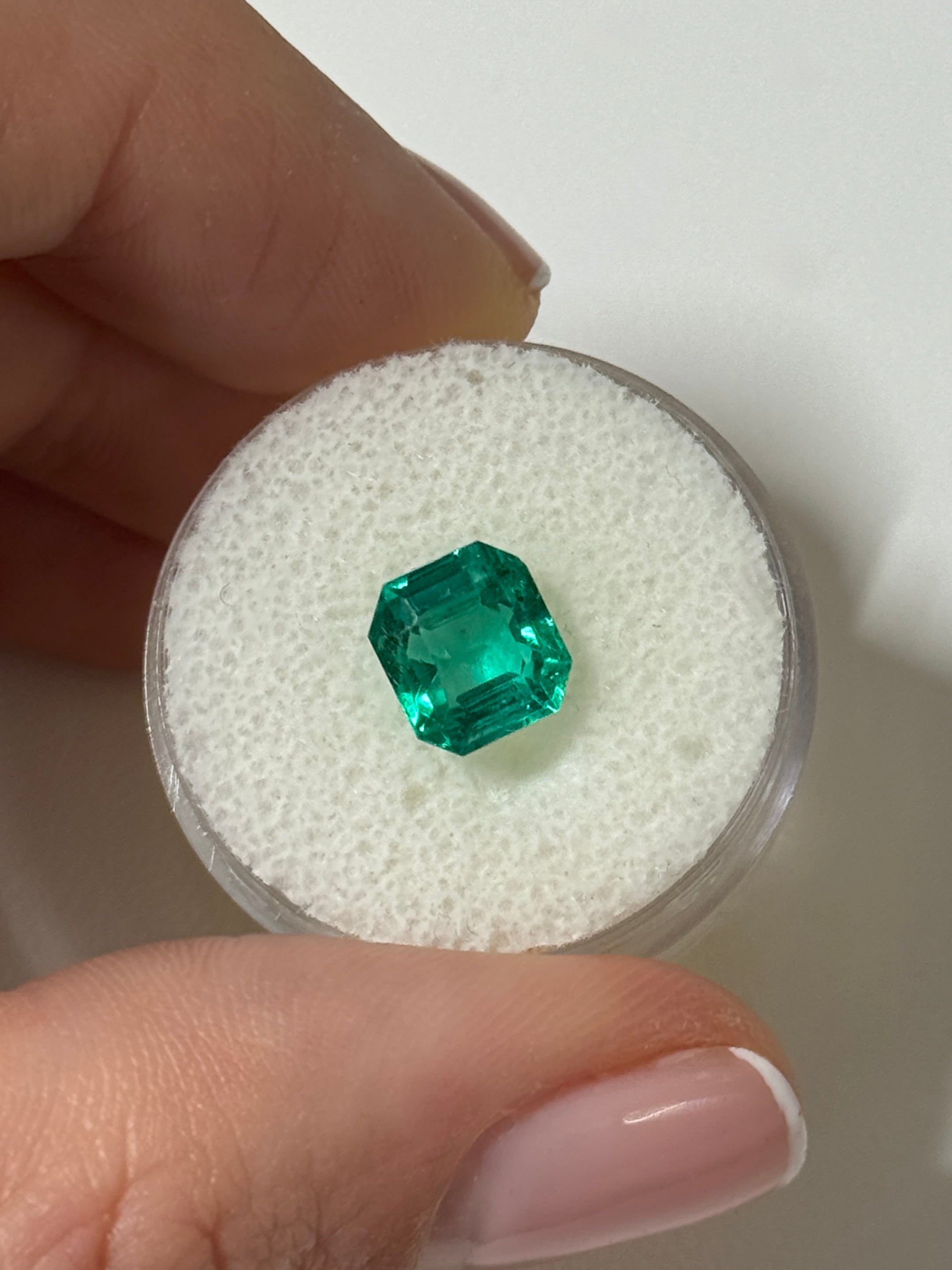 2.31 carat rare no-oil Colombian emerald in Asscher cut, showcased with its vibrant green color and clarity, by JR Colombian Emeralds.