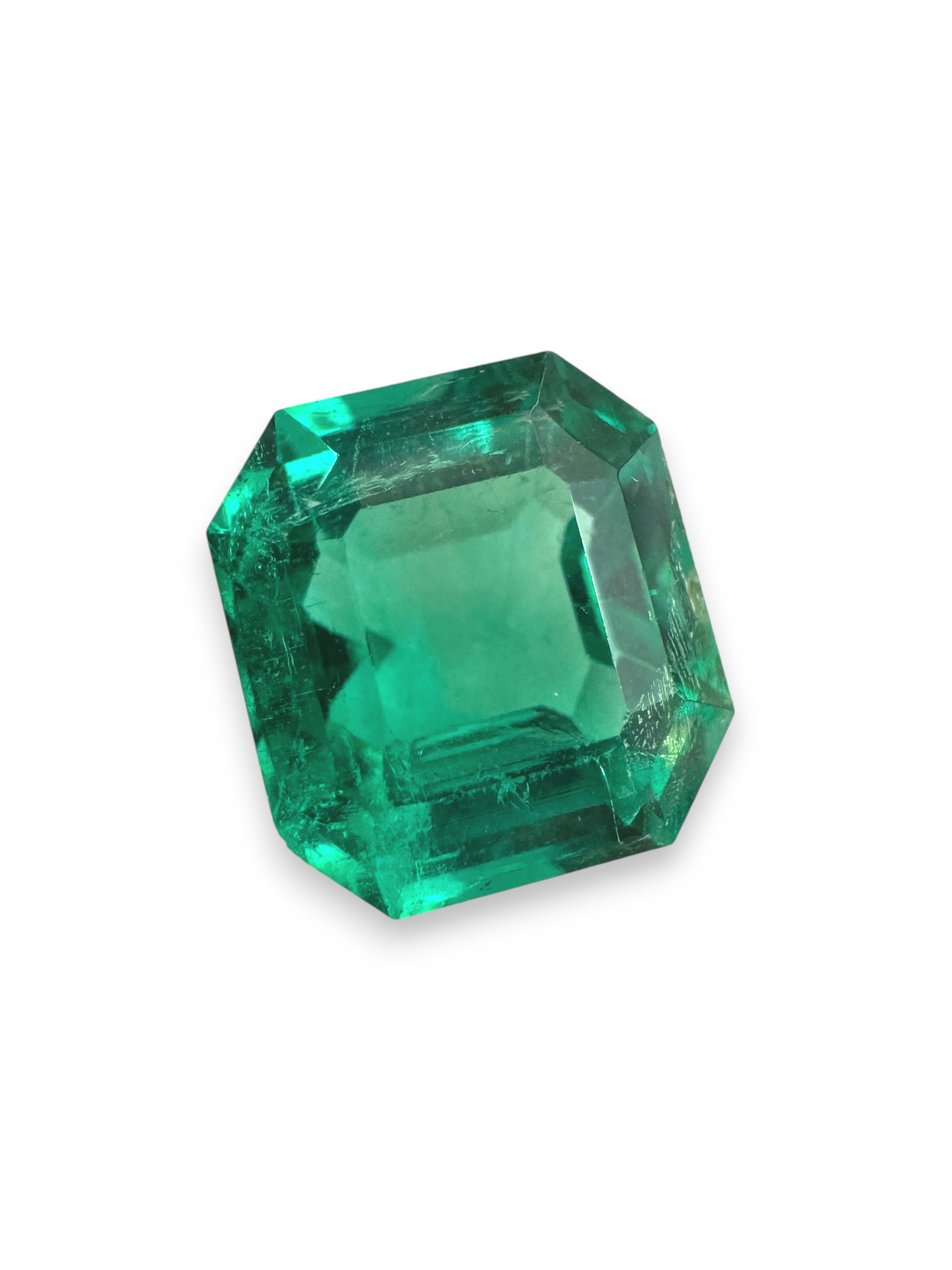 2.31-carat rare no-oil Colombian emerald in Asscher cut, displayed by JR Colombian Emeralds with vibrant green facets and clarity.