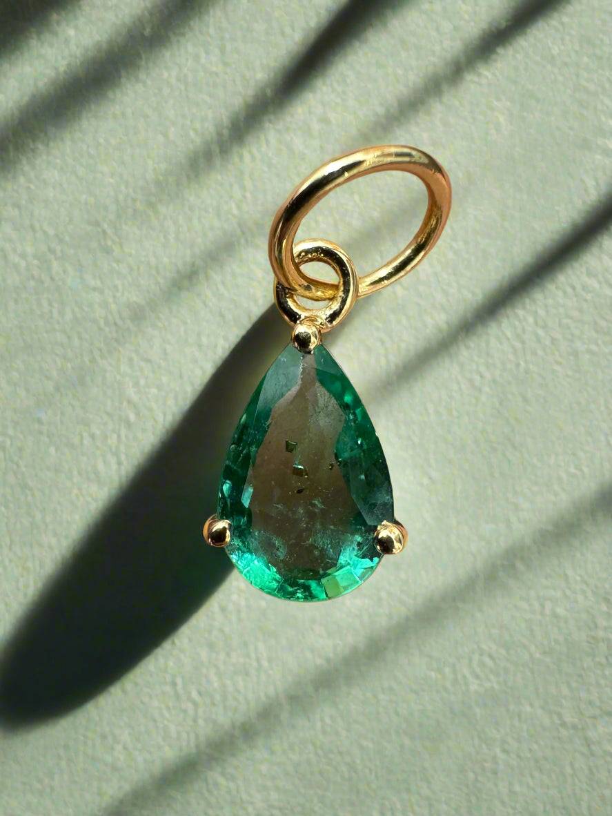 Petite 0.70ct natural freckled teardrop emerald pendant in 14K gold with prong setting, by JR Colombian Emeralds.