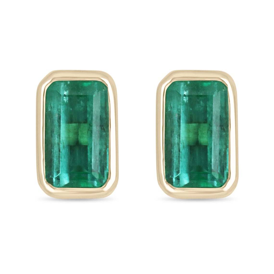 High-quality emerald cut Colombian emerald stud earrings set in 14K gold with bezel setting, showcasing vibrant green gemstones.