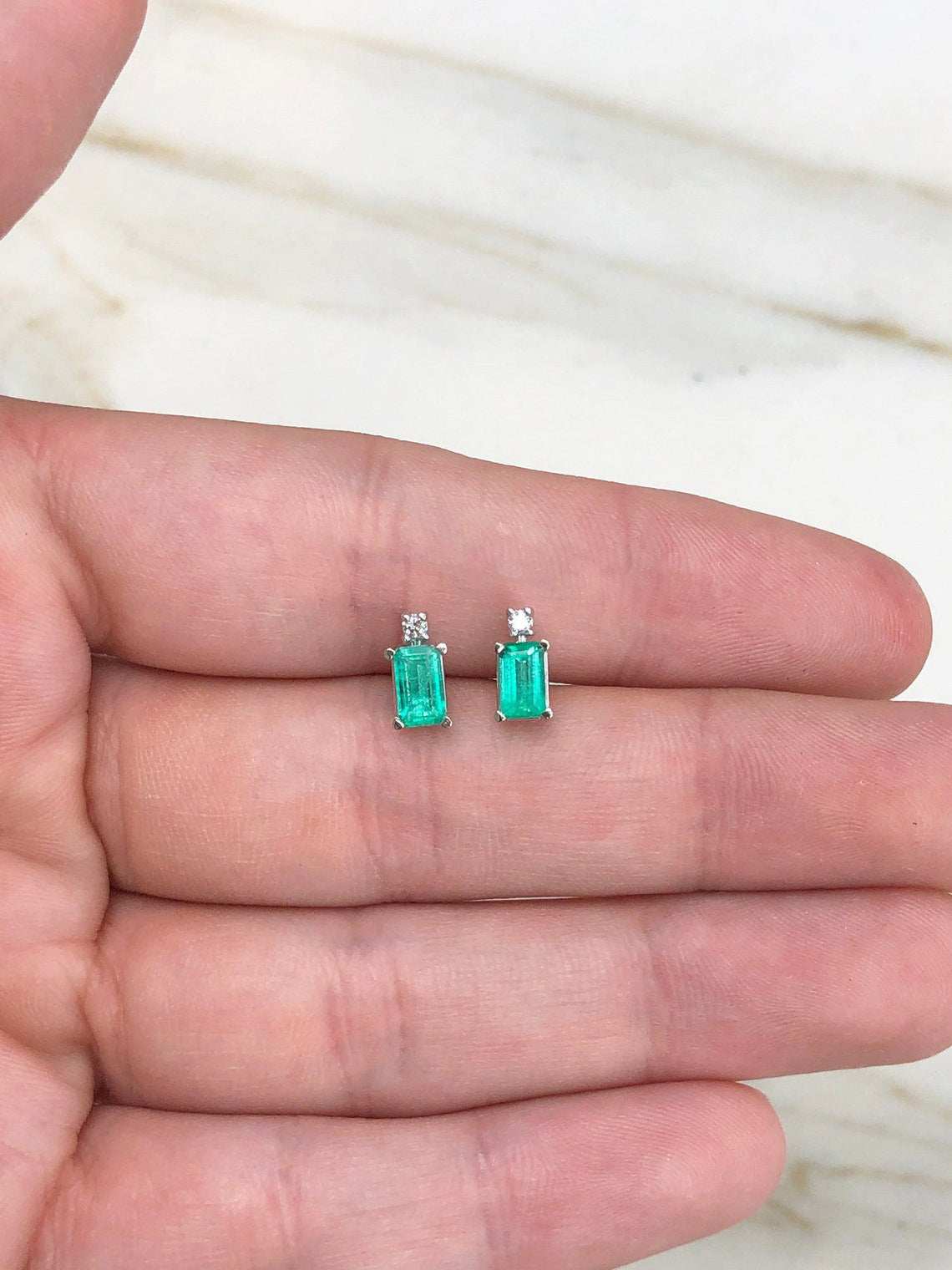 JR Colombian Emeralds 14K gold stud earrings with 1.56tcw earth-mined emeralds and diamonds, featuring a classic design.