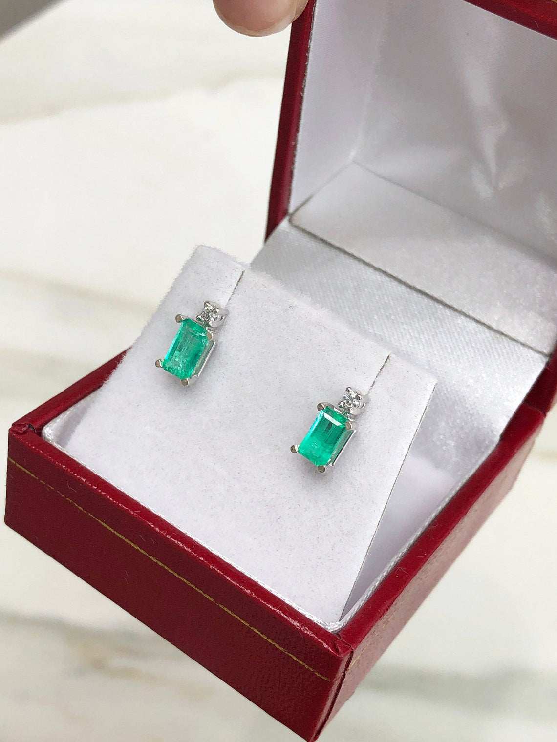 JR Colombian Emeralds stud earrings with 1.56 carats of earth-mined emeralds and diamonds in 14K white gold.