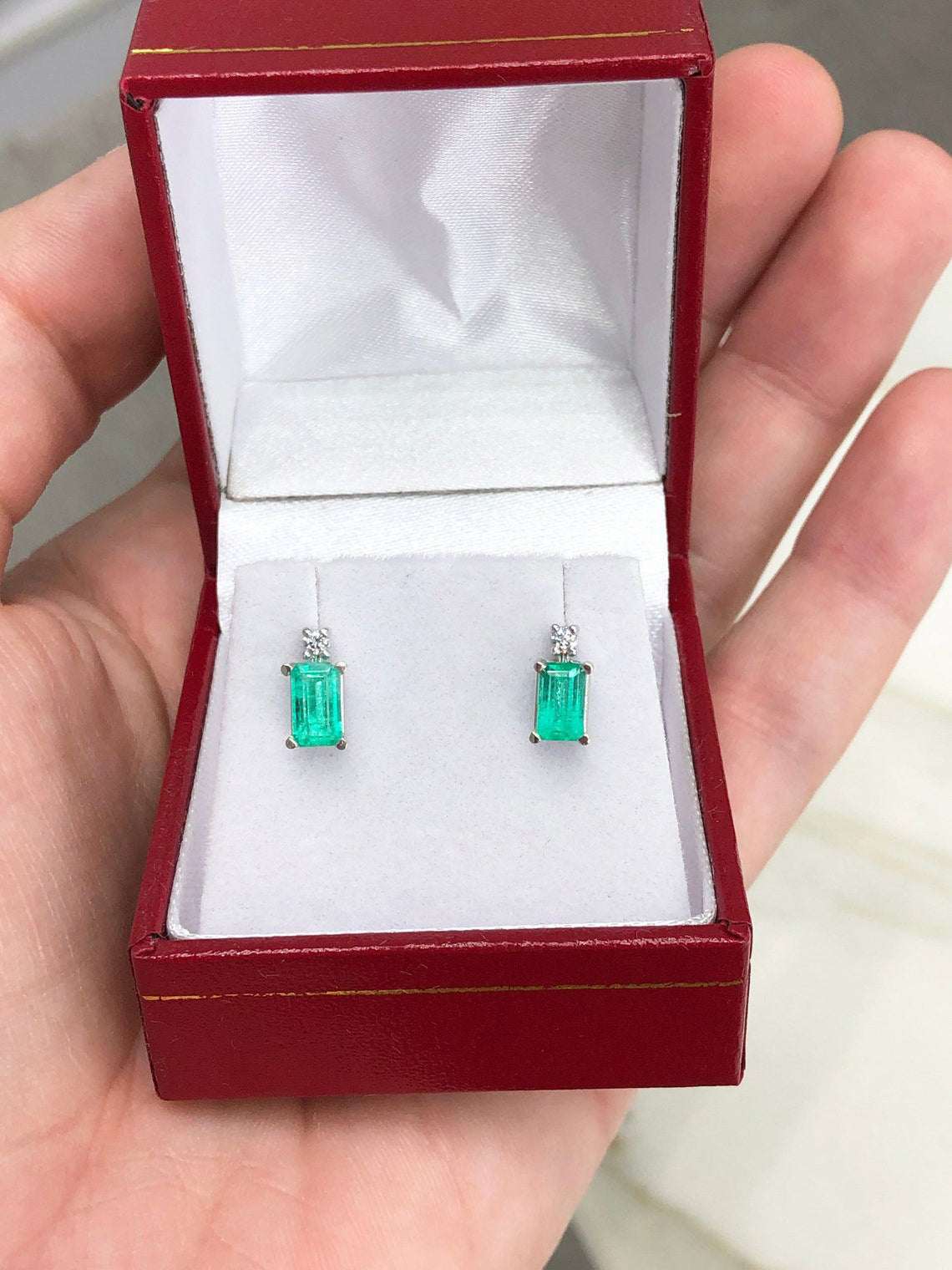 JR Colombian Emeralds 14K gold stud earrings with 1.56 carats of earth-mined emeralds and diamonds, featuring white gold setting.