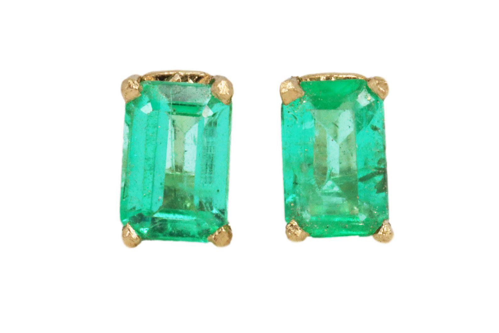Dainty four prong emerald cut green emerald stud earrings in 14K yellow gold