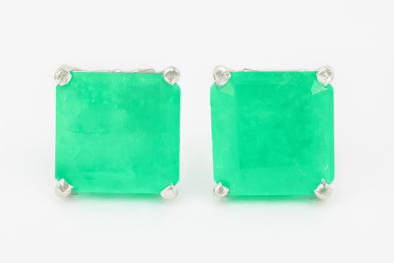 Pair of green square stud earrings on a white background
