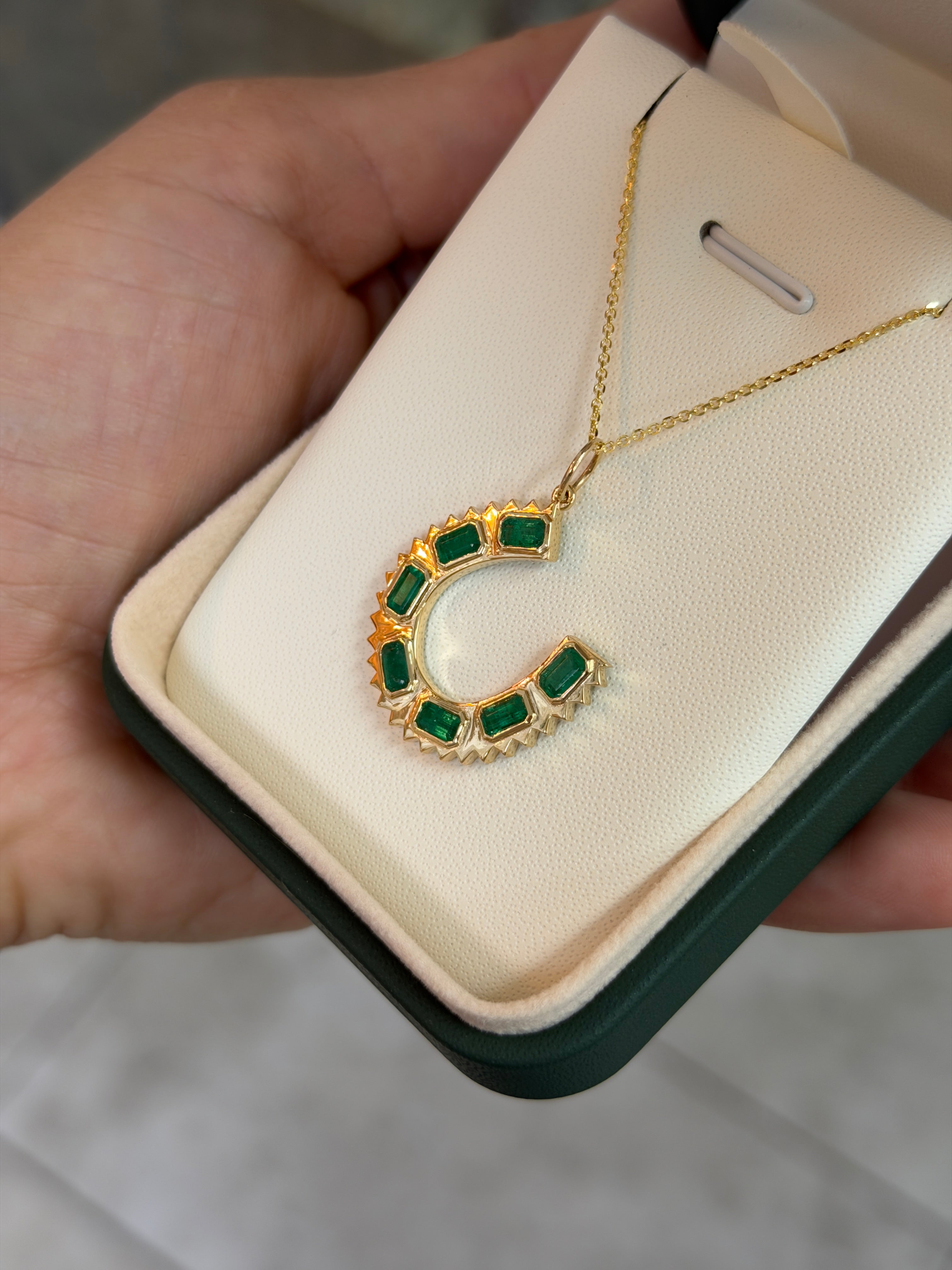 14K natural emerald cut emerald horseshoe charm pendant necklace with 2.24tcw from JR Colombian Emeralds.