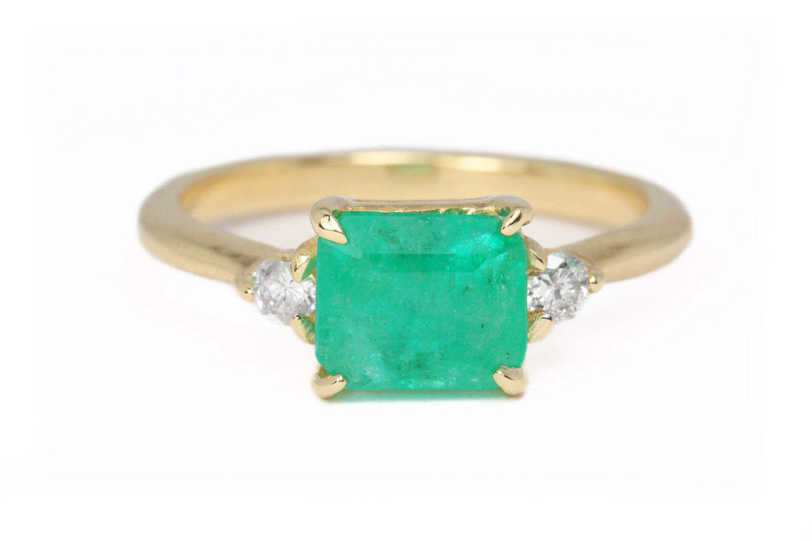 14K gold three-stone ring with 1.80ct emerald cut emerald and two round diamonds