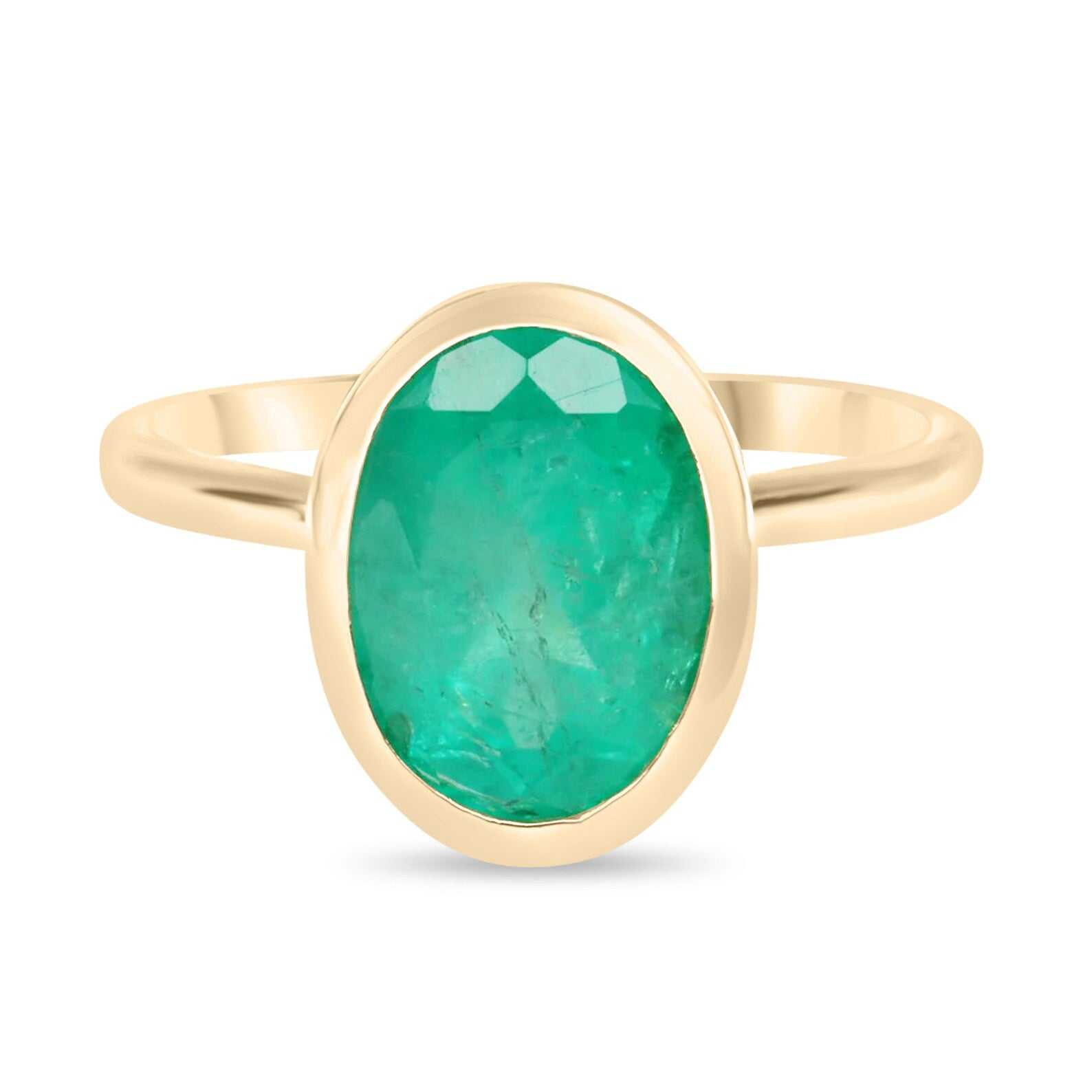 3.0 carat bezel set oval cut emerald ring in 14K yellow gold solitaire setting