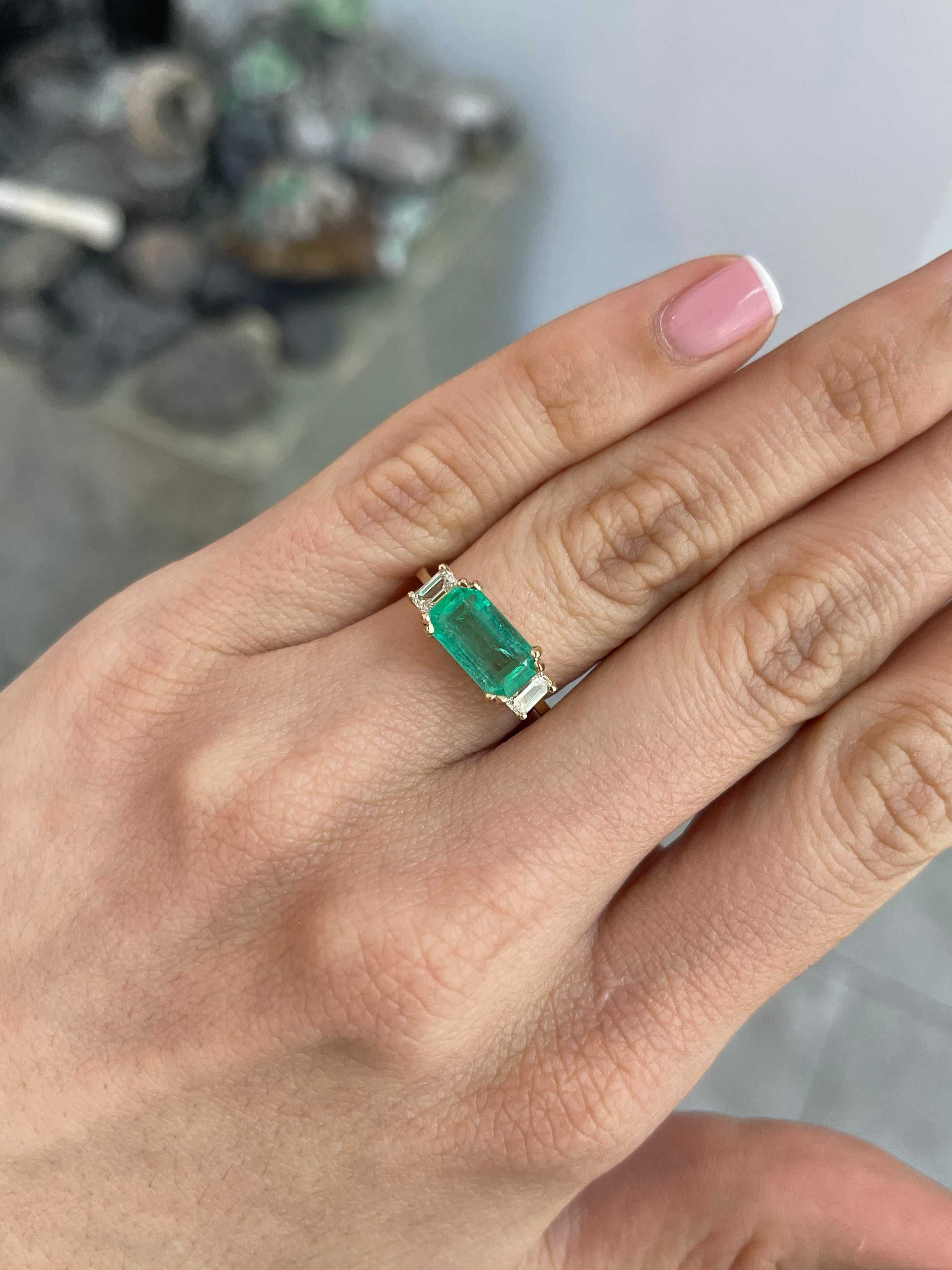 Three stone emerald and emerald cut diamond engagement ring in 14K gold by JR Colombian Emeralds, showcasing vibrant green stones.