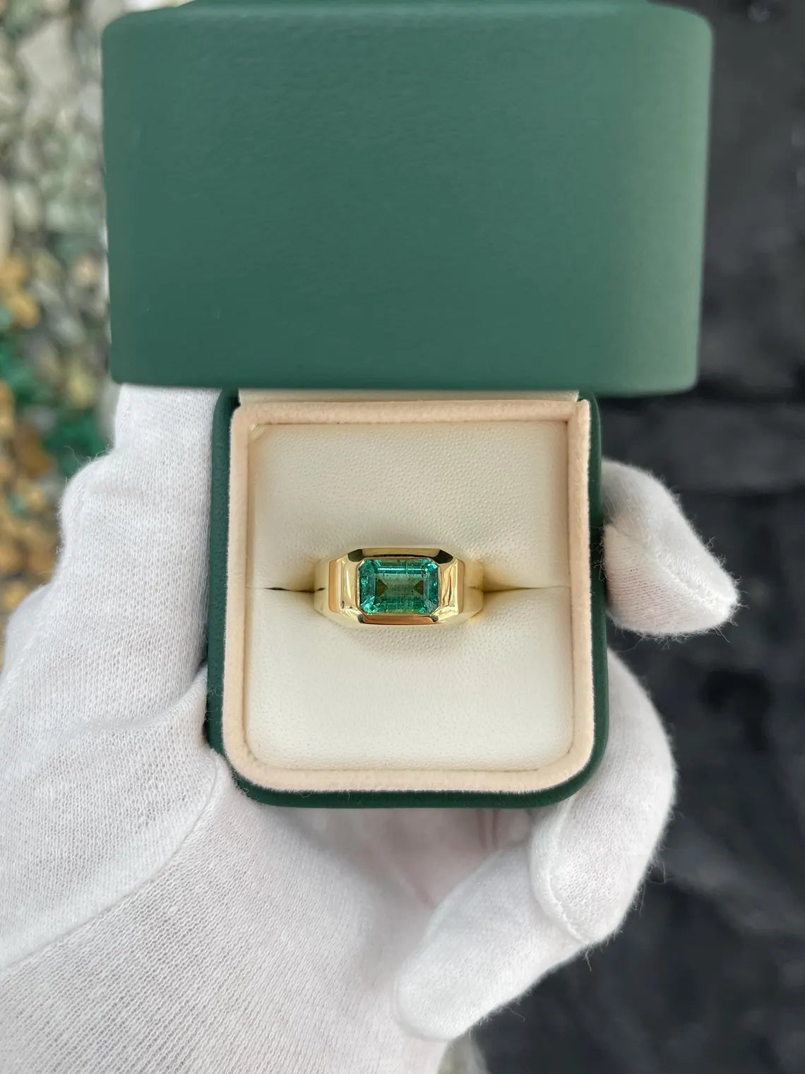 Men's ring featuring a 2.66 carat natural emerald cut emerald in a blue-green bezel setting by JR Colombian Emeralds.