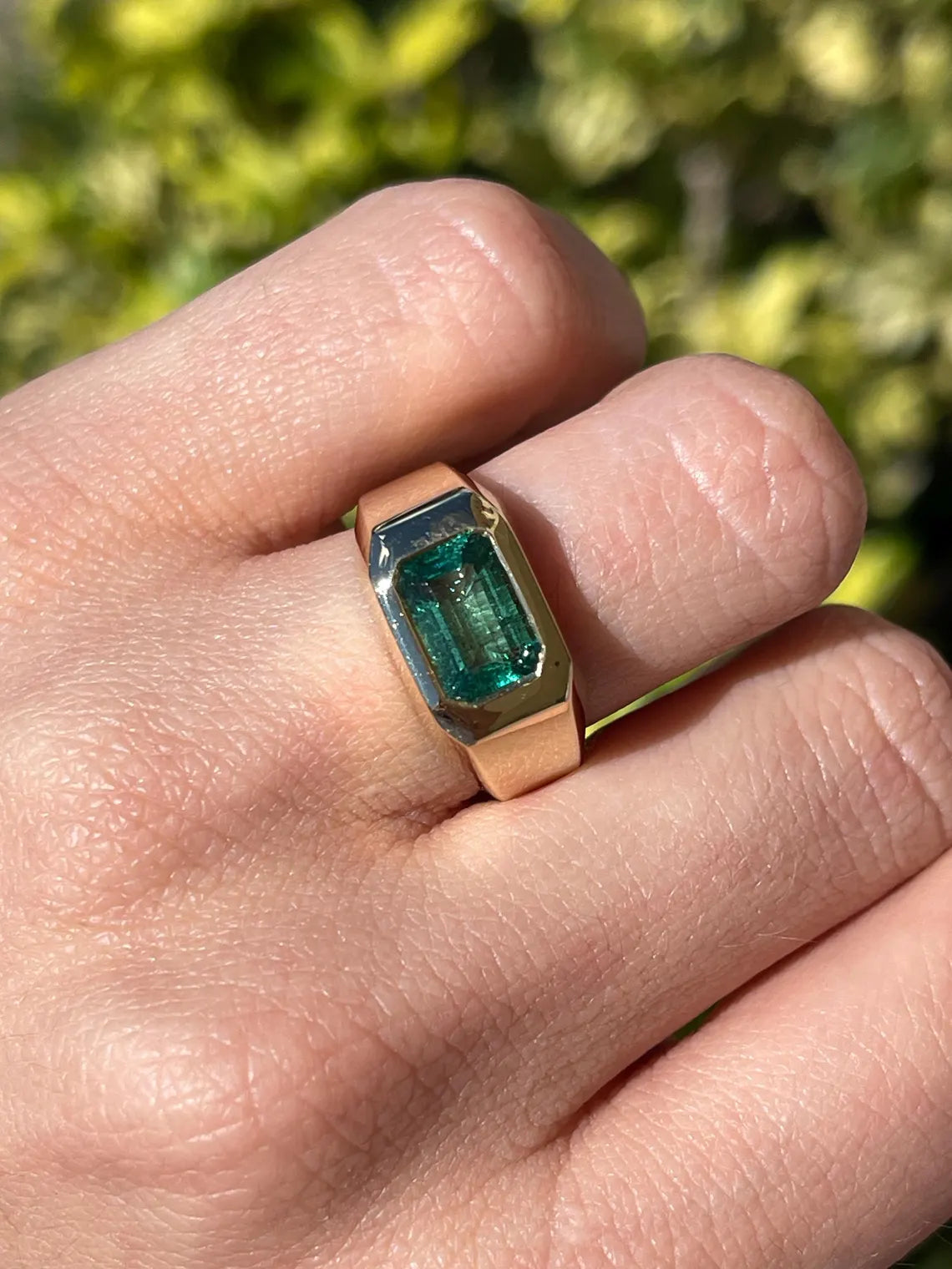 Men's ring featuring a 2.66 carat natural emerald cut emerald in a bluish green bezel setting, by JR Colombian Emeralds.