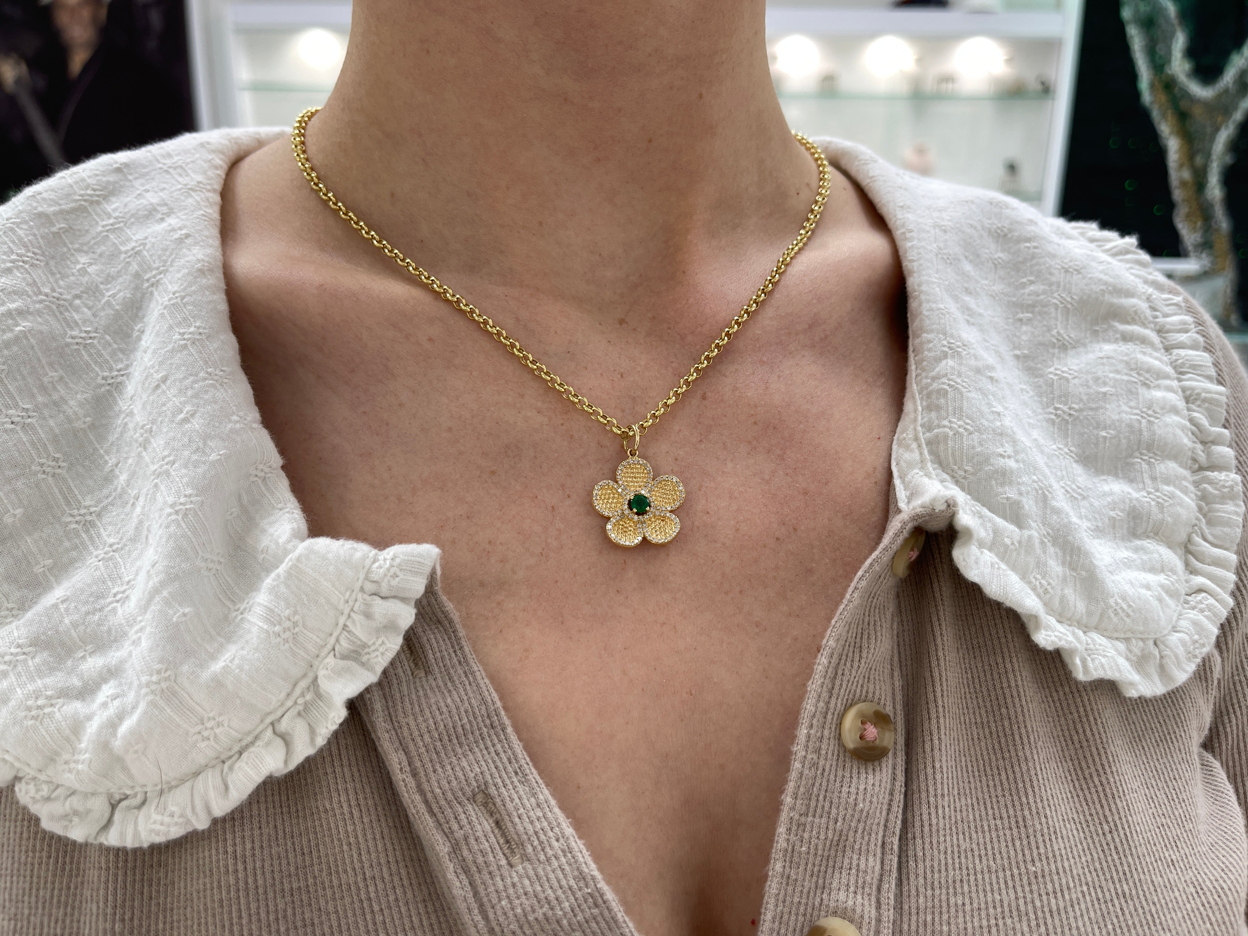 14K gold flower pendant with 0.58 carats emerald and diamond accents, beautifully crafted by JR Colombian Emeralds.