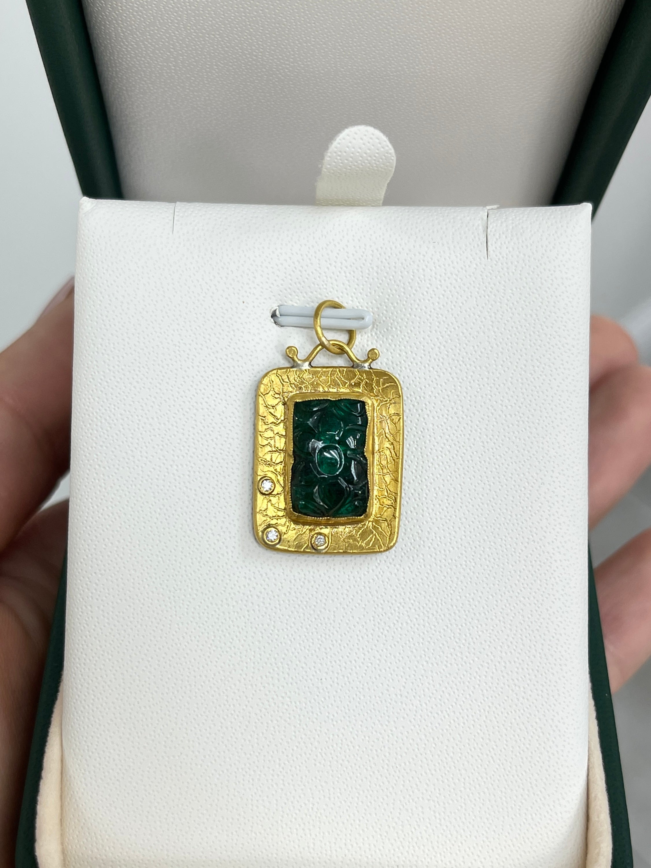Floral hand-carved 6.35ct emerald and diamond pendant in 24K gold by JR Colombian Emeralds on a white background.