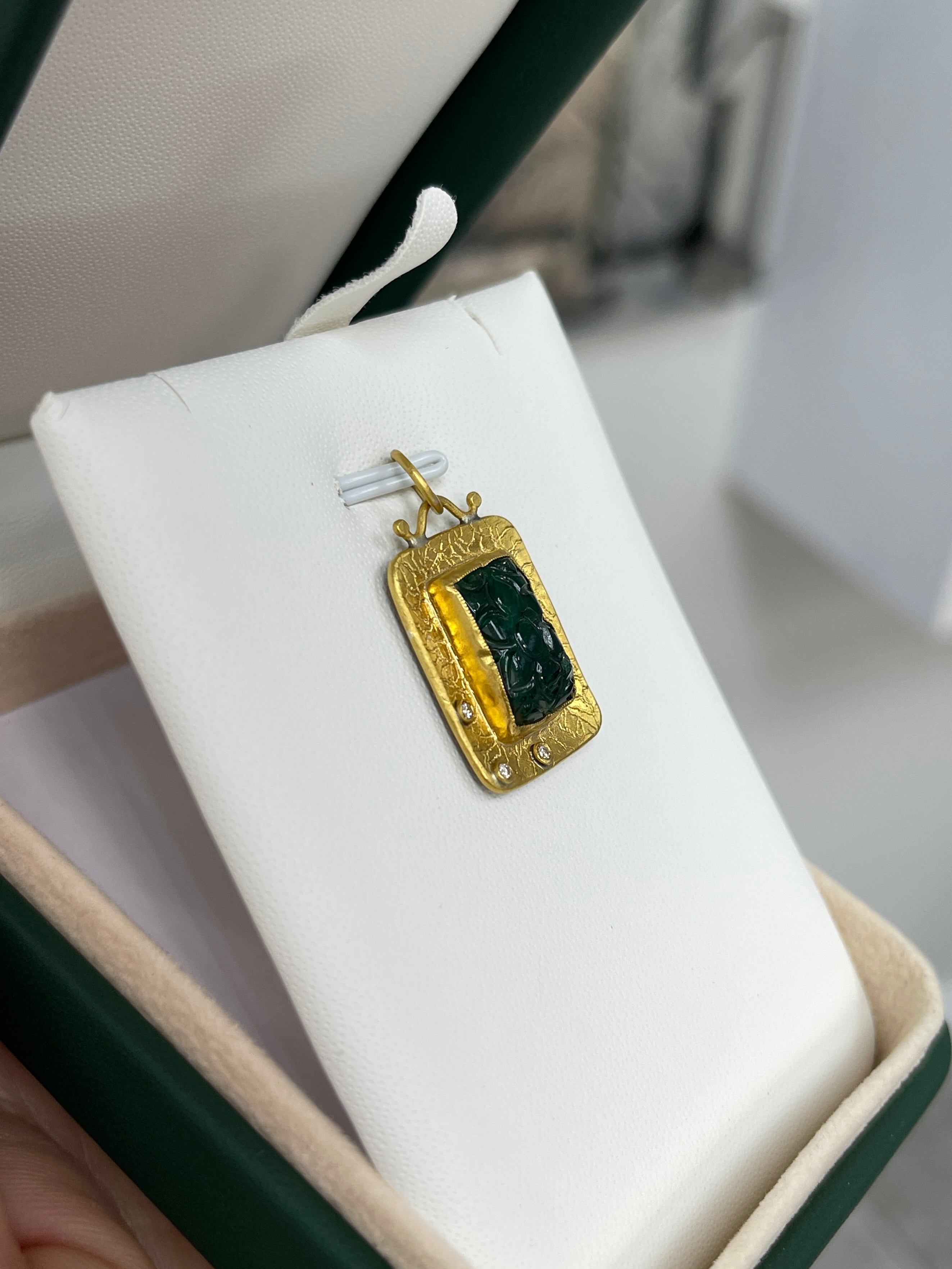 Floral hand-carved emerald and diamond pendant in 24K gold by JR Colombian Emeralds, showcasing intricate craftsmanship.