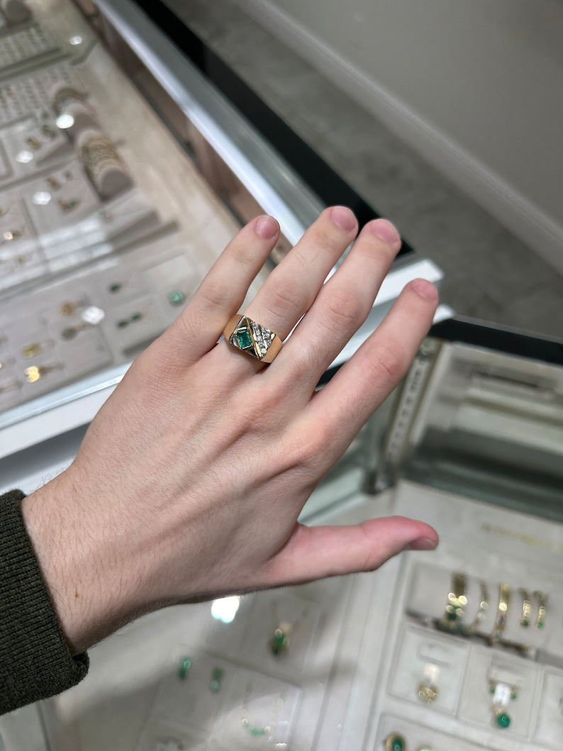 14K gold men's signet ring with lush green round cut emerald and diamond accents, featuring a bold, polished design.