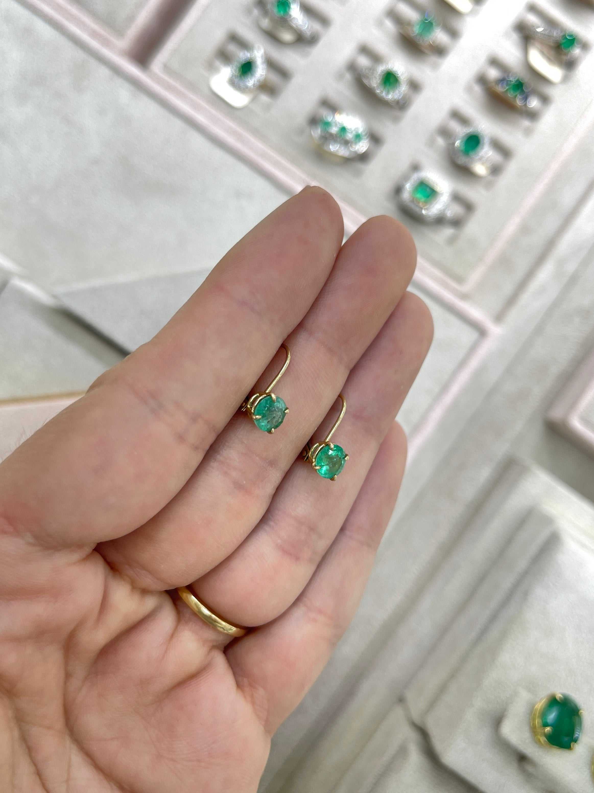 14K yellow gold round emerald lever back earrings with 1.50 carats total weight, featuring vibrant emerald gemstones.