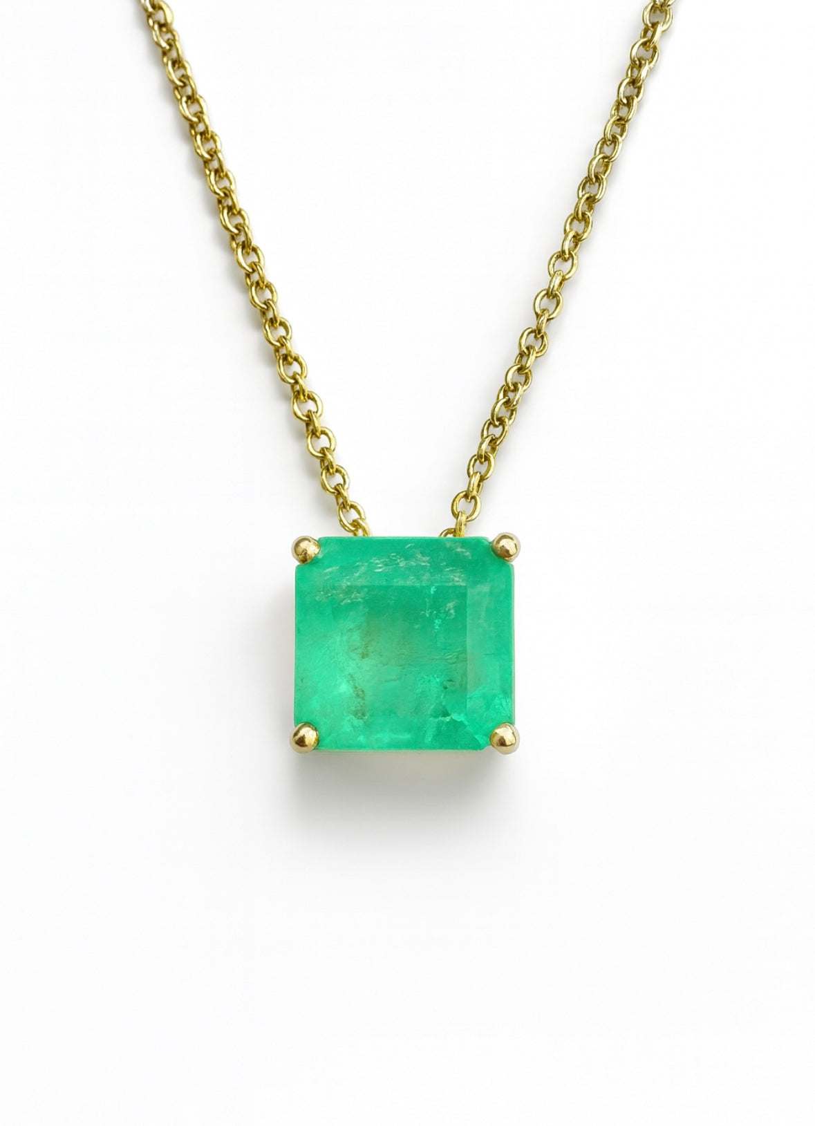 Asscher cut Colombian emerald pendant on a 14K sliding necklace with gold chain, jewelry featuring a 3.0 carat emerald stone.