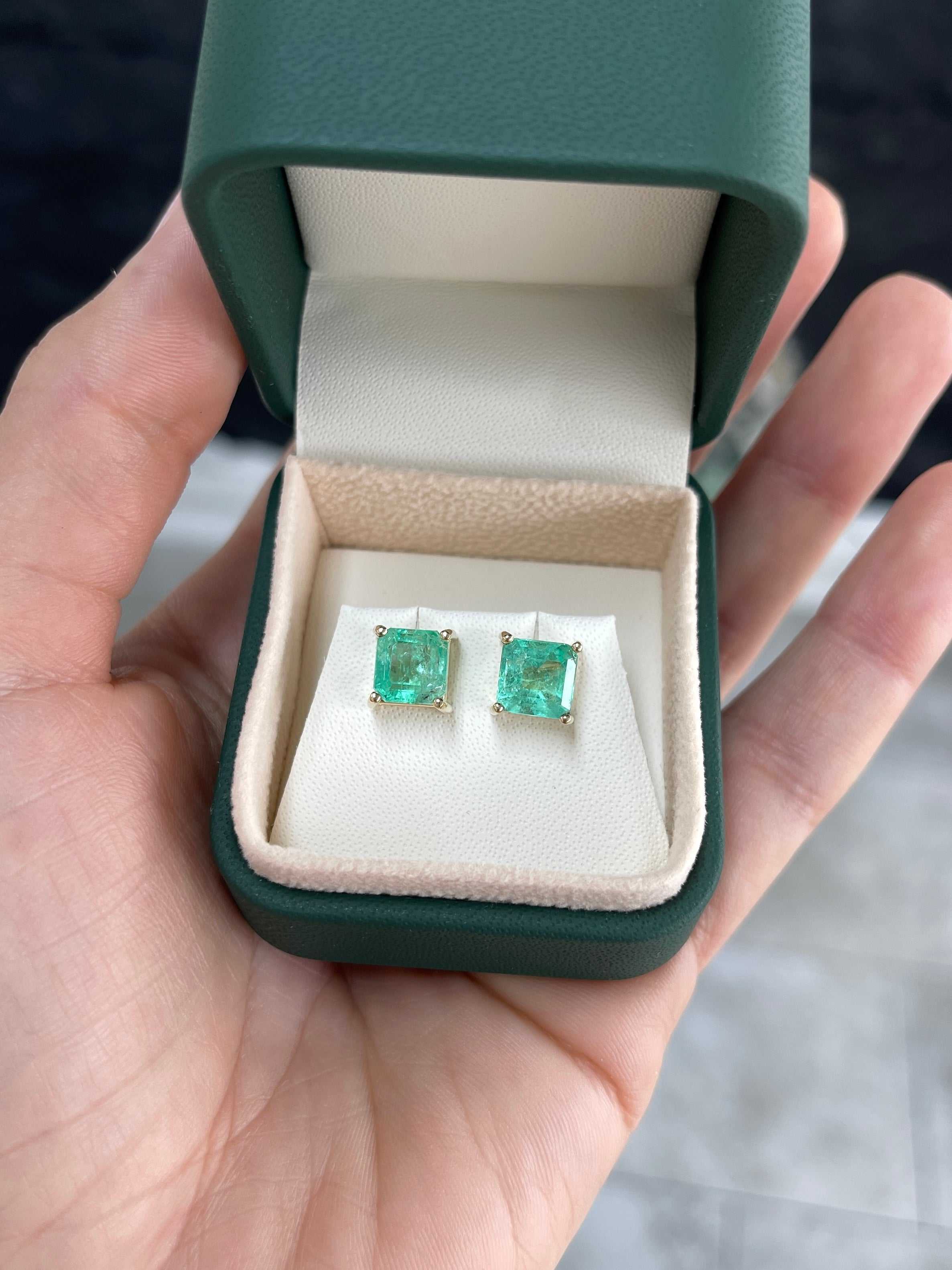 Asscher cut Colombian emerald stud earrings with 3.97tcw earthy-spring green gemstones set in 14K gold.